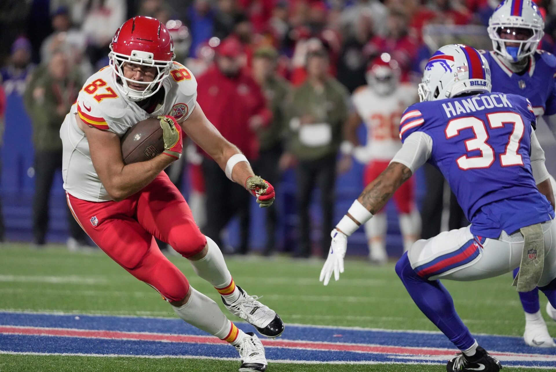 Kansas City Chiefs tight end Travis Kelce catches a pass and tries to avoid Buffalo Bills cornerback Jordan Hancock during first half action against the Kansas City Chiefs at Highmark Stadium in Orchard Park on Nov. 2, 2025.