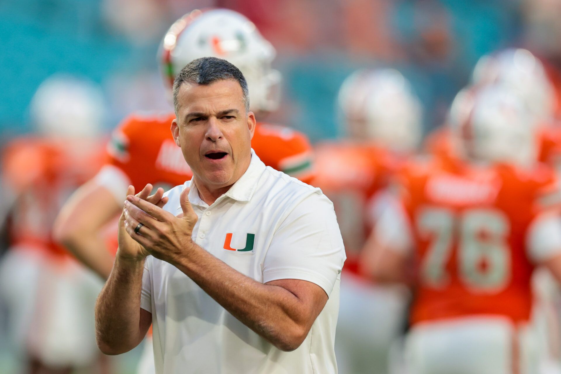 Miami Hurricanes head coach Mario Cristobal works with his players before the game against the Louisville Cardinals at Hard Rock Stadium.