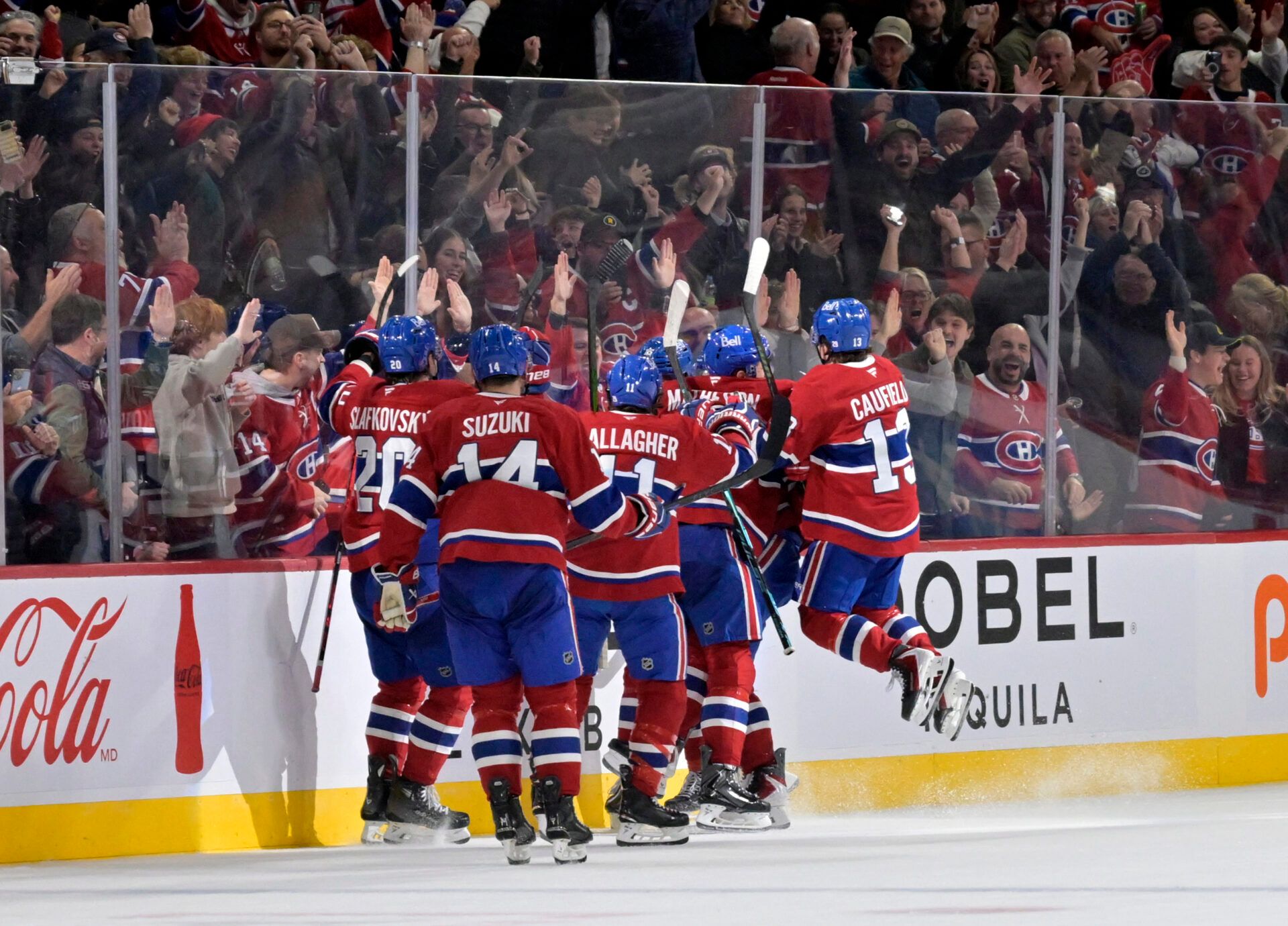 Montreal Canadiens forward Alex Newhook (15) celebrates with teammates after scoring the winning goal against the Ottawa Senators during the overtime period at the Bell Centre.