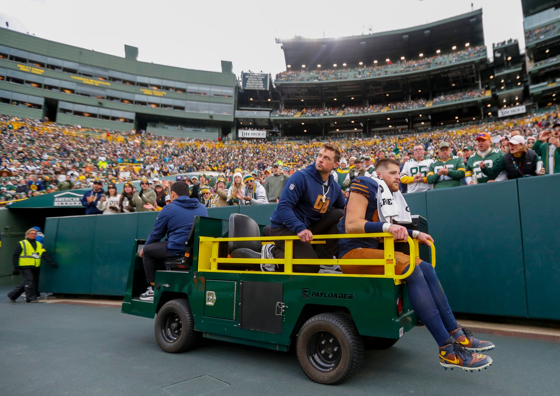 Green Bay Packers tight end Tucker Kraft is carted off the field after suffering a knee injury against the Carolina Panthers during the game at Lambeau Field.
