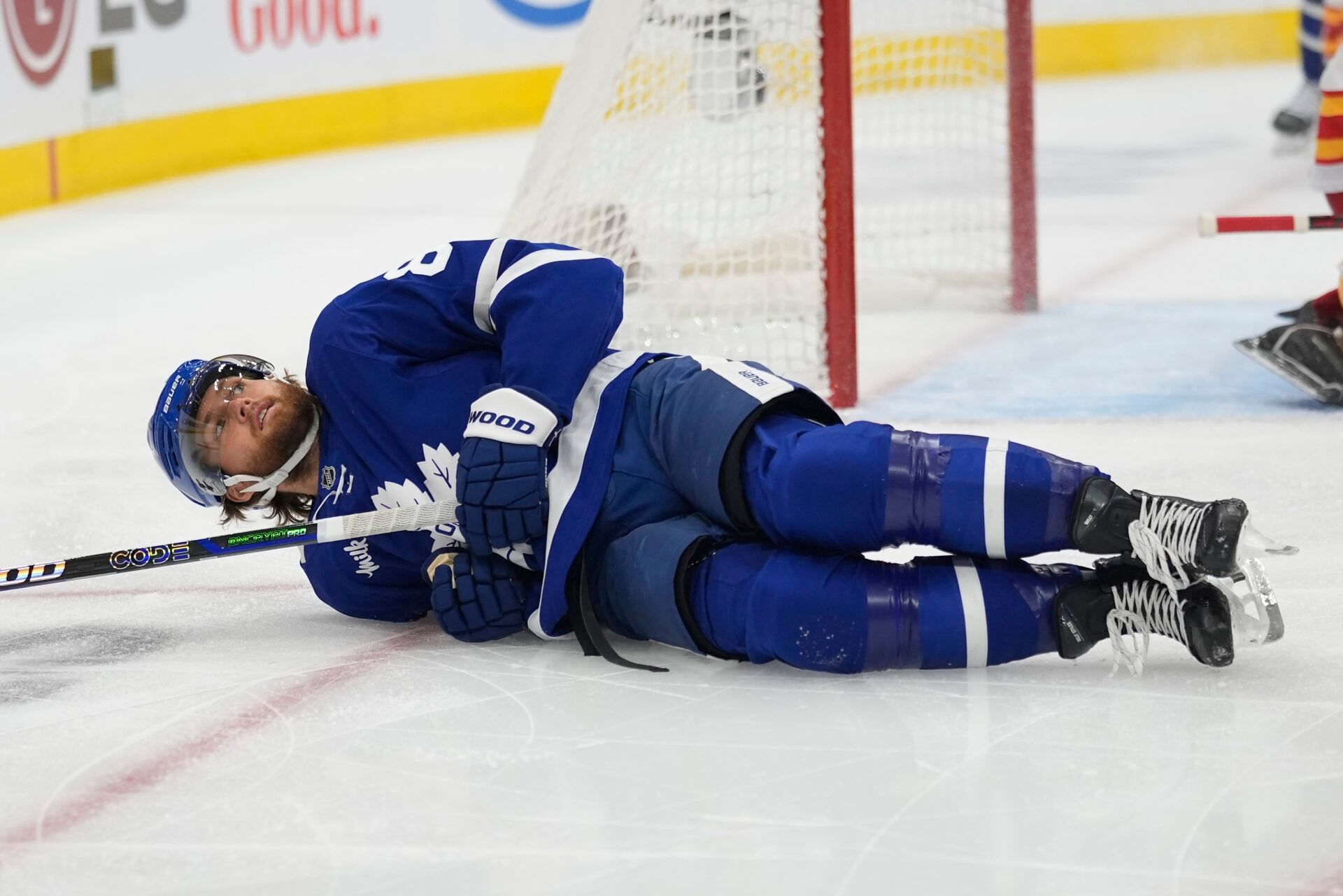 Toronto Maple Leafs forward William Nylander (88) lies on the ice after a collision wit a Calgary Flames player during the first period at Scotiabank Arena.