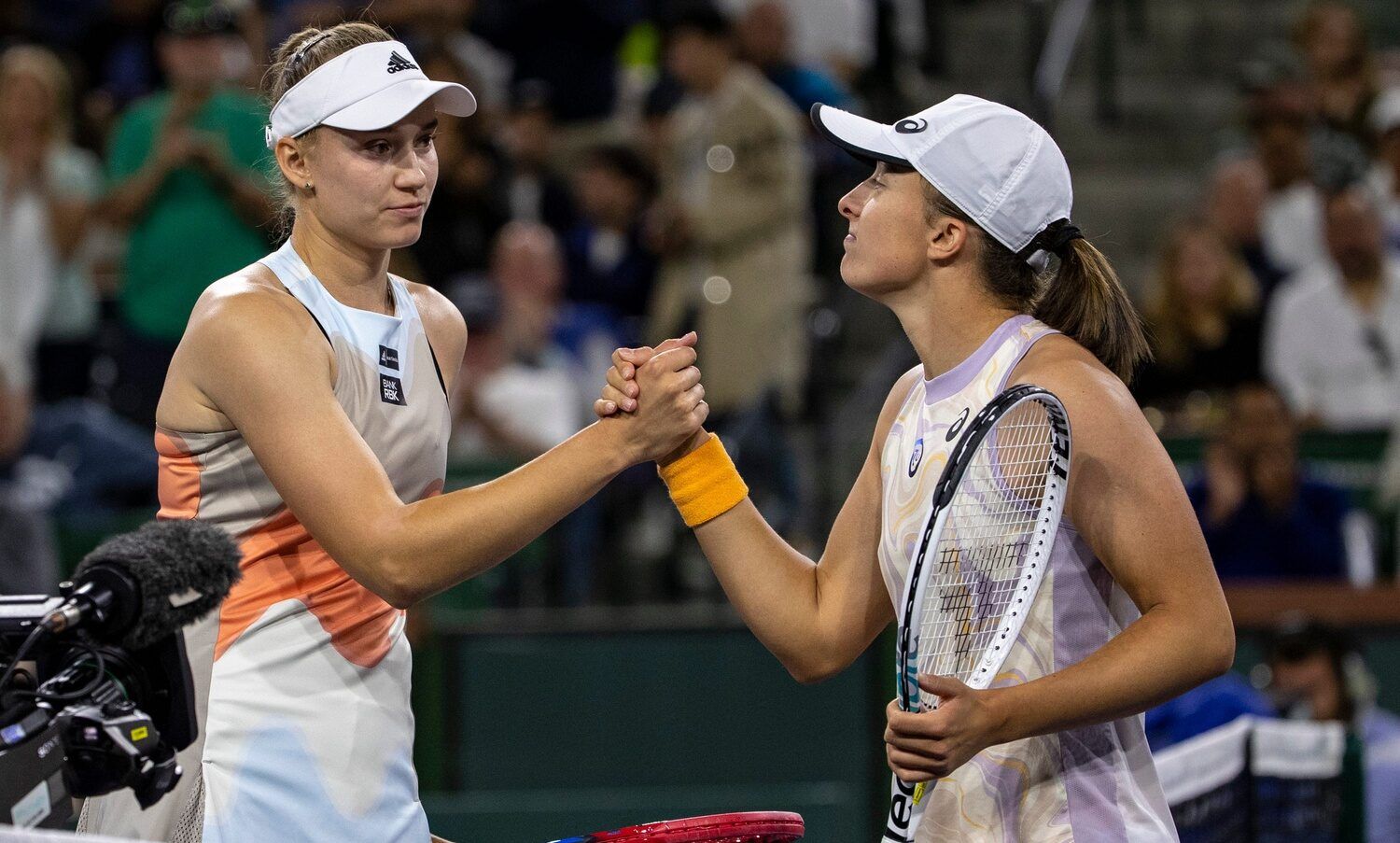 Elena Rybakina of Kazakhstan (left) shakes hands with Iga Swiatek of Poland after their semifinal match at the BNP Paribas Open at the Indian Wells Tennis Garden in Indian Wells, Calif., Friday, March 17, 2023.