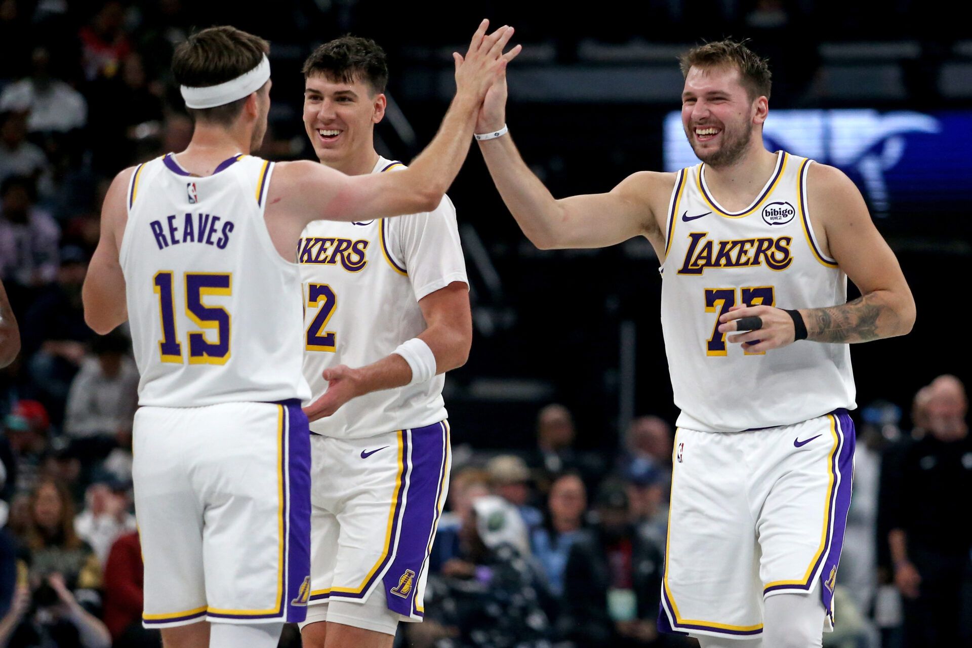 Los Angeles Lakers guard Luka Doncic (77) reacts with guard Austin Reaves (15) during a timeout during the second quarter against the Memphis Grizzlies at FedExForum.