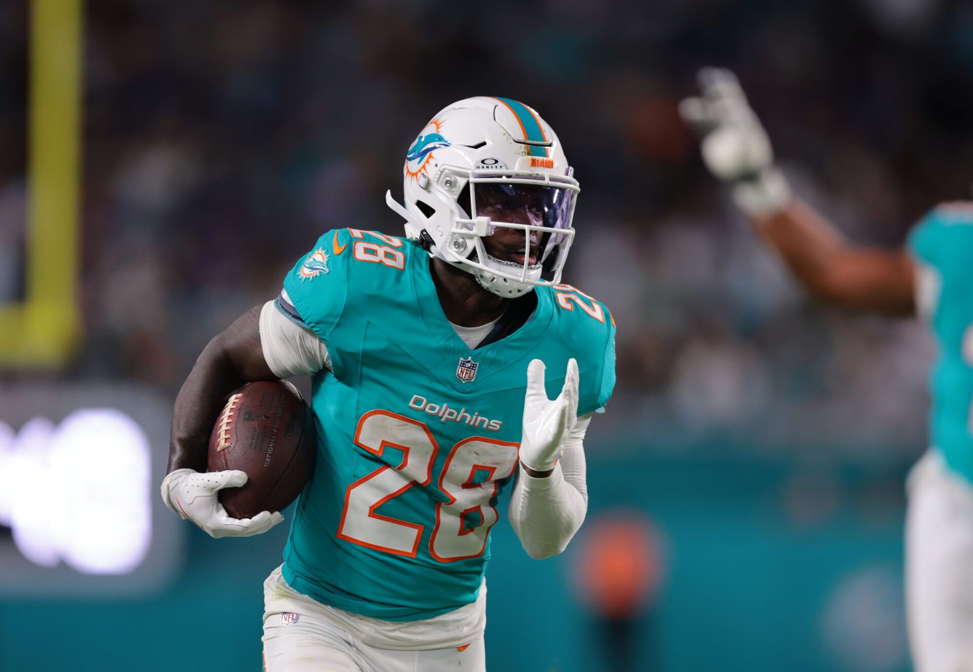Miami Dolphins running back De'Von Achane (28) runs for a gain during the first quarter against the Baltimore Ravens at Hard Rock Stadium.