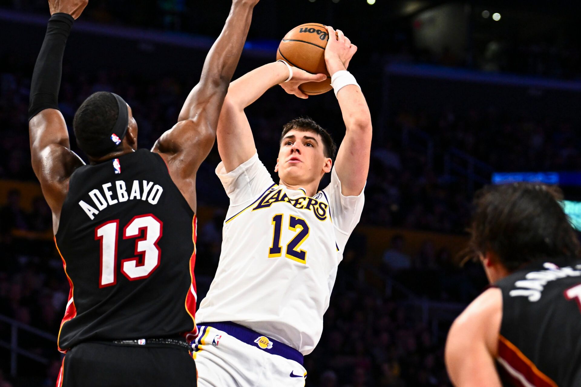 Los Angeles Lakers forward Jake Laravia (12) shoots against Miami Heat center/forward Bam Adebayo (13) during the second half at Crypto.com Arena.