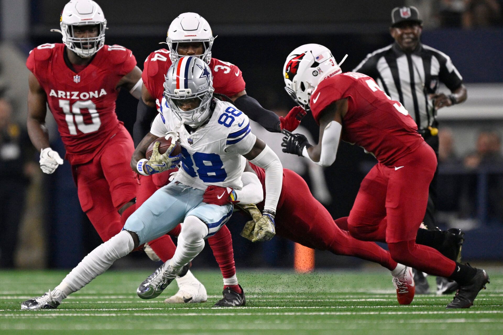 Dallas Cowboys wide receiver CeeDee Lamb (88) runs against Arizona Cardinals safety Jalen Thompson (34) and safety Budda Baker (3) in the first half at AT&T Stadium.