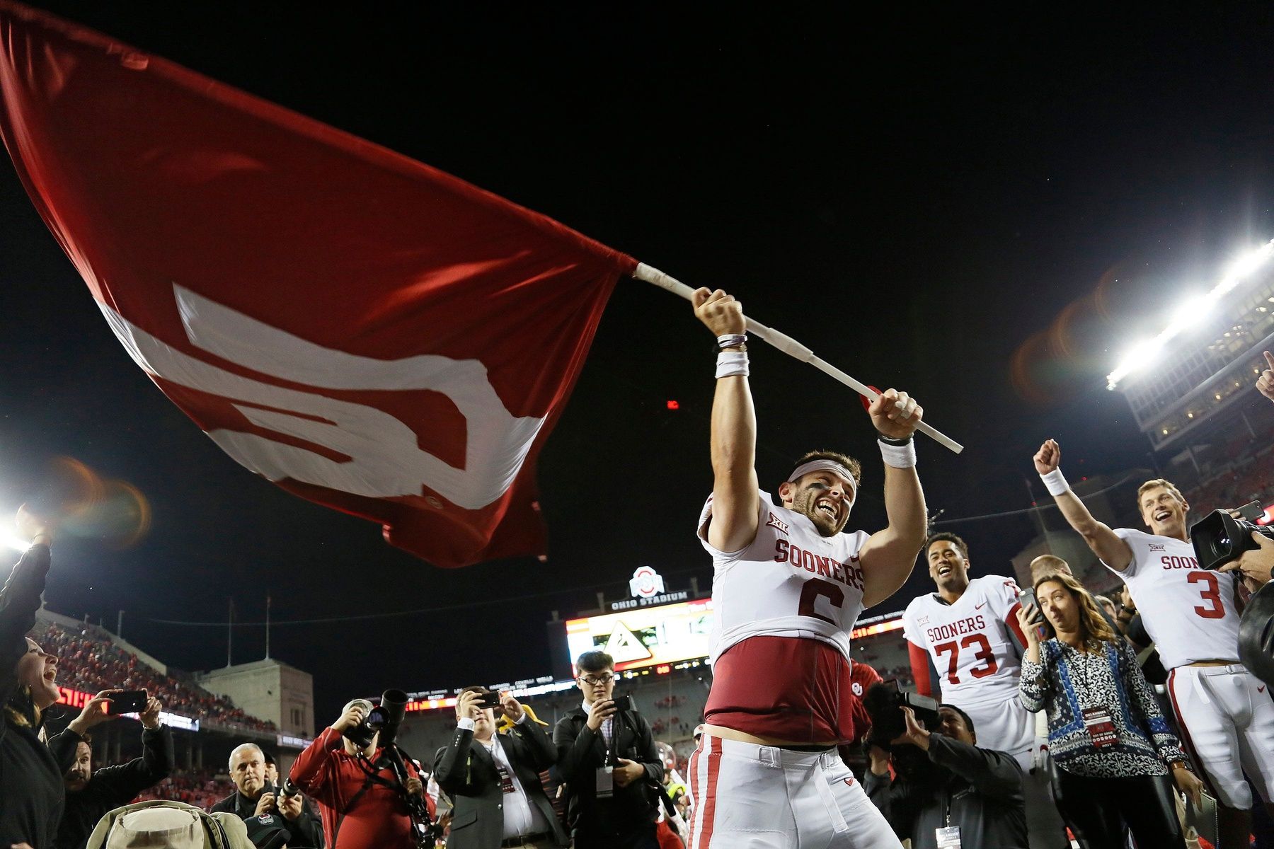 Oklahoma Sooners quarterback Baker Mayfield (6) waves the school flag following their 31-16 win over the Ohio State Buckeyes during NCAA football game at Ohio Stadium in Columbus on Sept. 9, 2017. [Adam Cairns/Dispatch]
