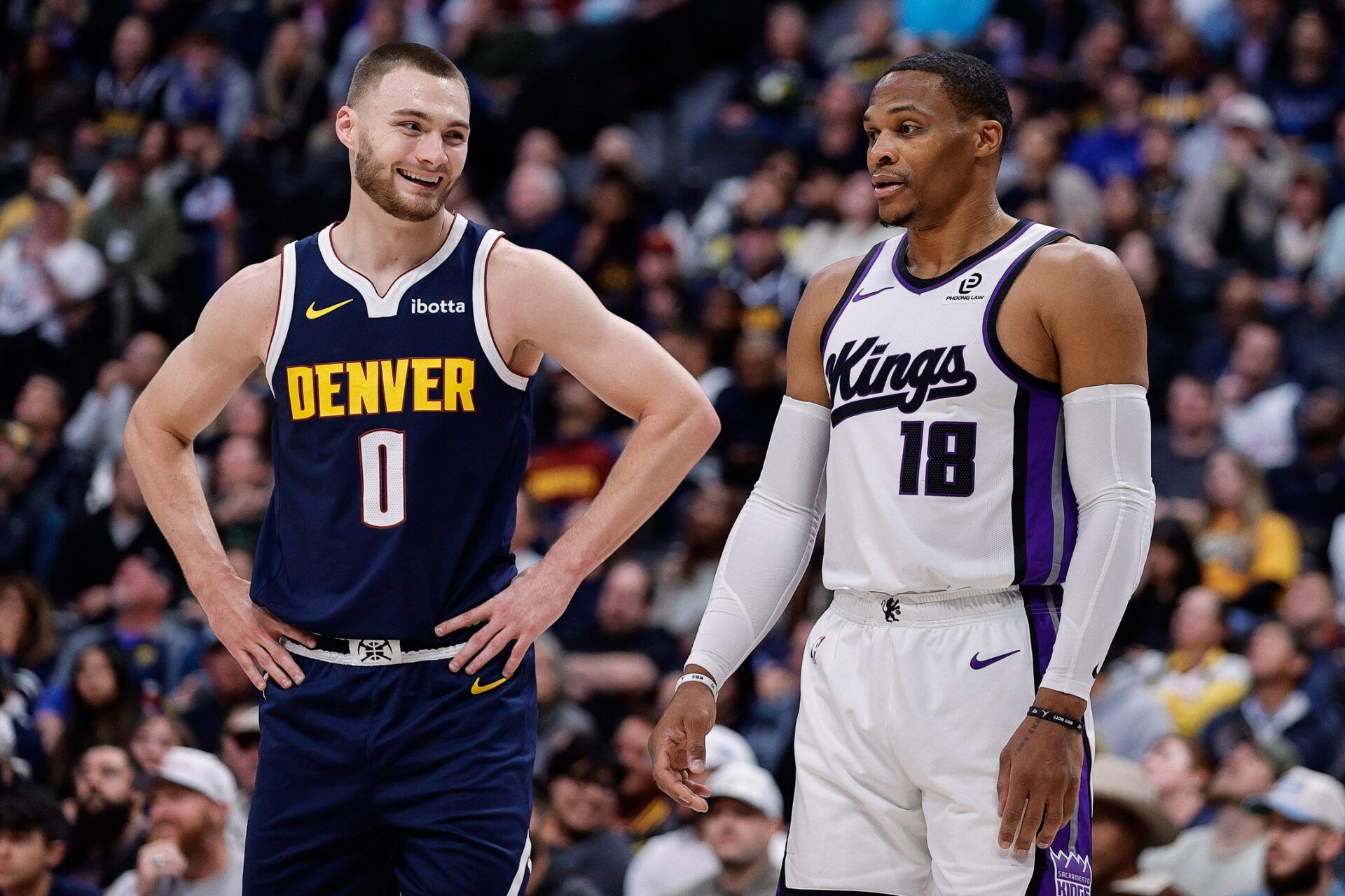 Denver Nuggets guard Christian Braun (0) and Sacramento Kings guard Russell Westbrook (18) in the first quarter at Ball Arena.