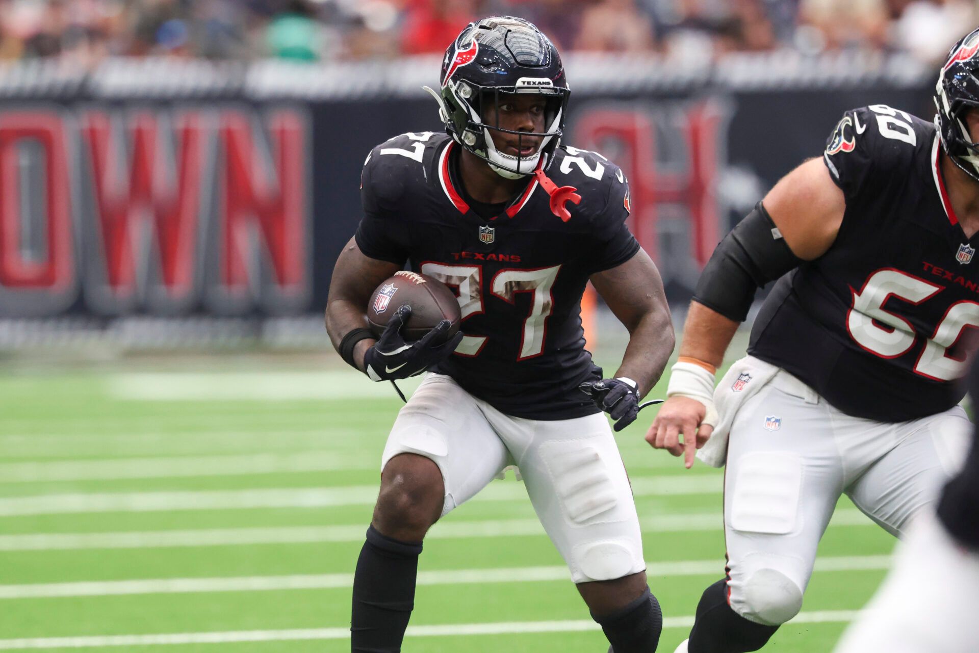 Houston Texans running back Woody Marks (27) runs with the ball during the fourth quarter against the Tennessee Titans at NRG Stadium.