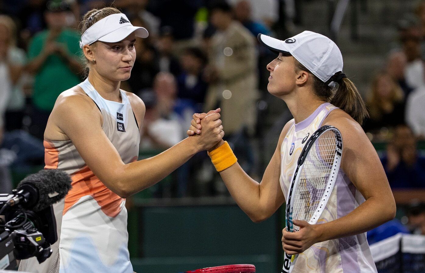 Elena Rybakina of Kazakhstan (left) shakes hands with Iga Swiatek of Poland after their semifinal match at the BNP Paribas Open at the Indian Wells Tennis Garden in Indian Wells, Calif., Friday, March 17, 2023.