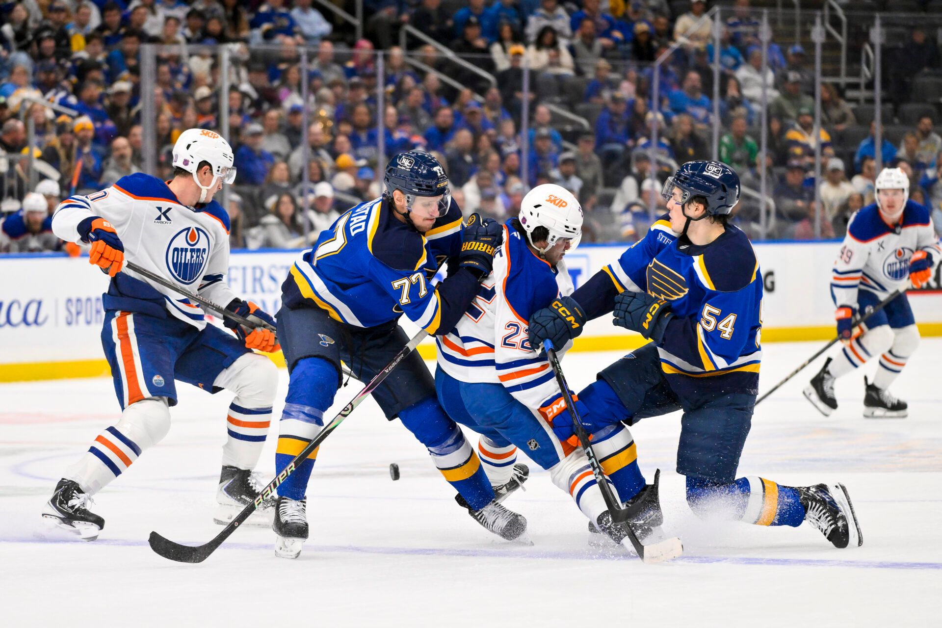 St. Louis Blues center Nick Bjugstad (77) and right wing Dalibor Dvorsky (54) defend against Edmonton Oilers center Matt Savoie (22) during the third period at Enterprise Center.