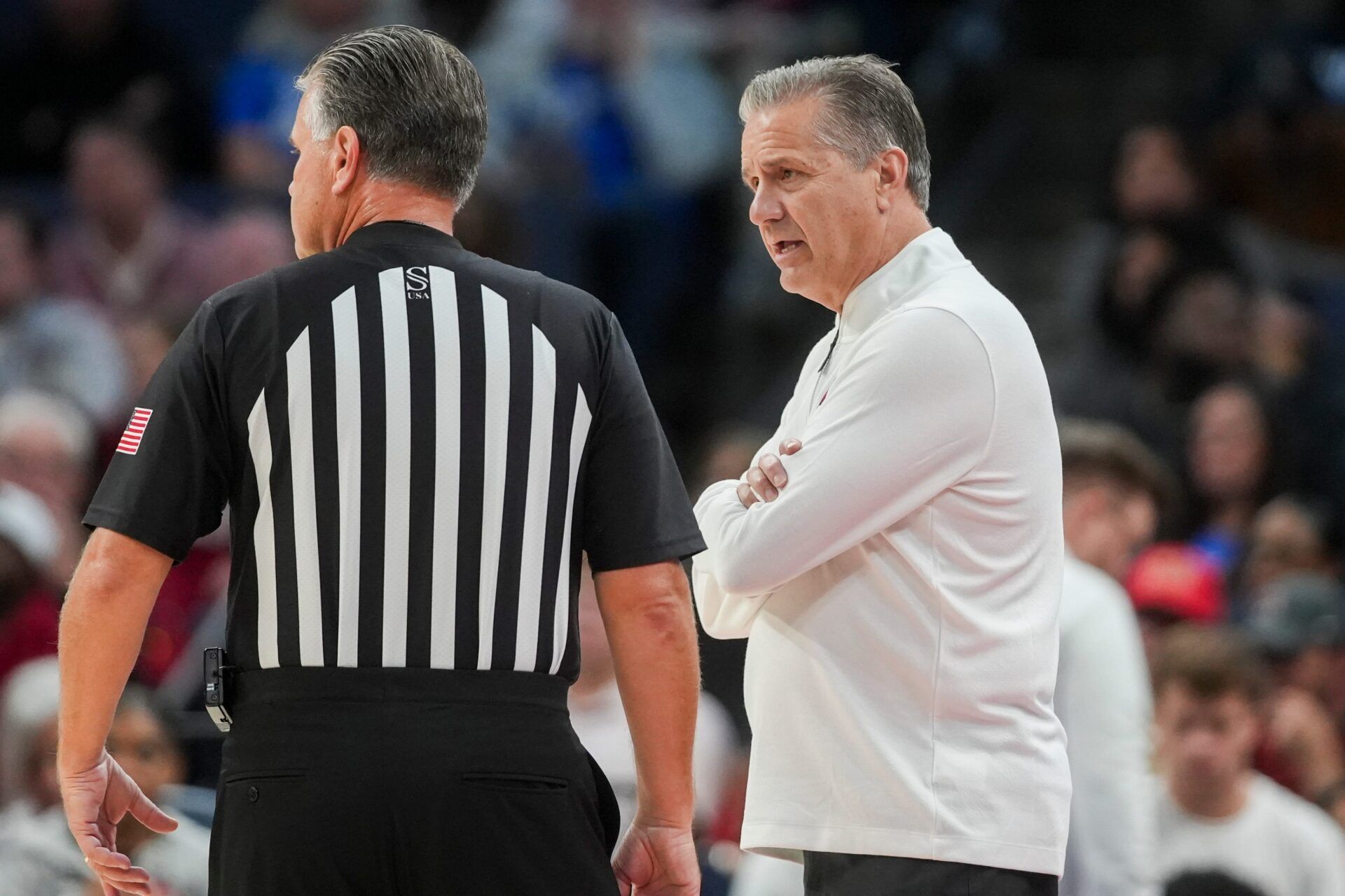 Arkansas' head coach John Calipari speaks with an official during the exhibition game between Arkansas and Memphis during the Hoops for St. Jude Tip Off Classic at FedExForum on October 27, 2025.