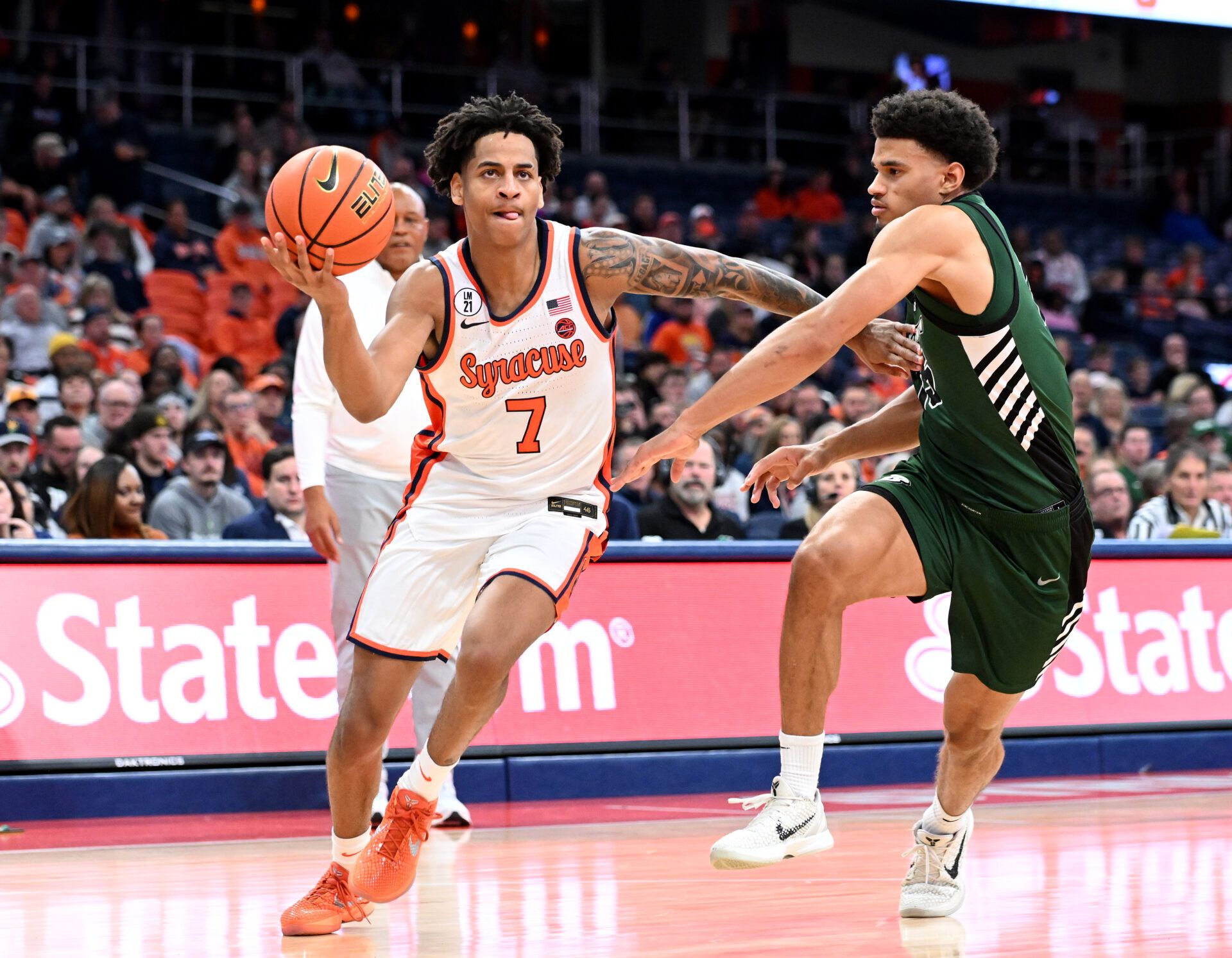 Syracuse Orange forward Kiyan Anthony (7) drives to basket as Binghamton Bearcats guard Bryson Wilson (15) defends in the second half at the JMA Wireless Dome.
