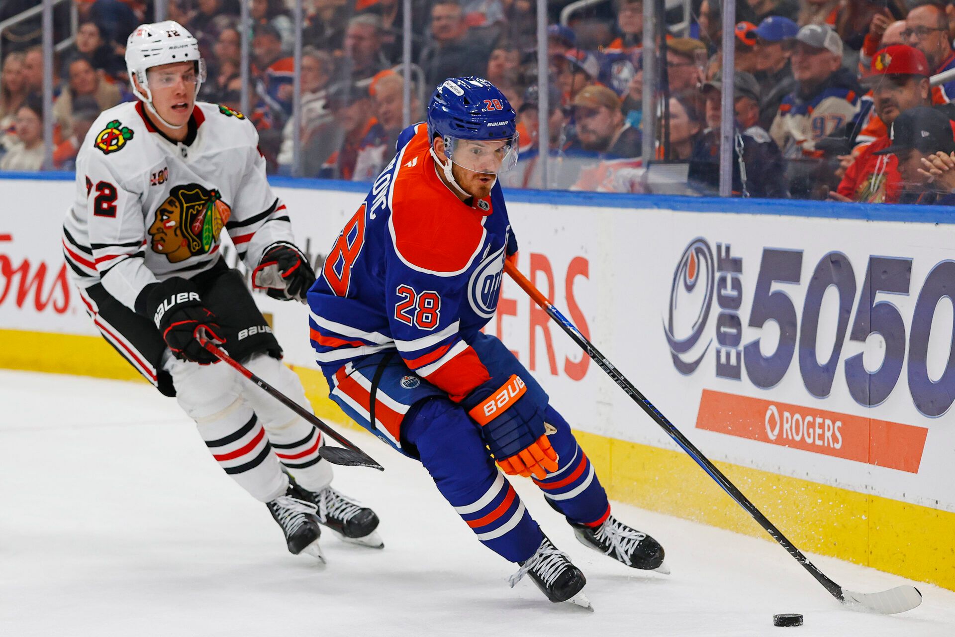 Edmonton Oilers forward Jack Roslovic (28) protects the puck from Chicago Blackhawks defensemen Alex Vlasic (72) during the third period at Rogers Place.