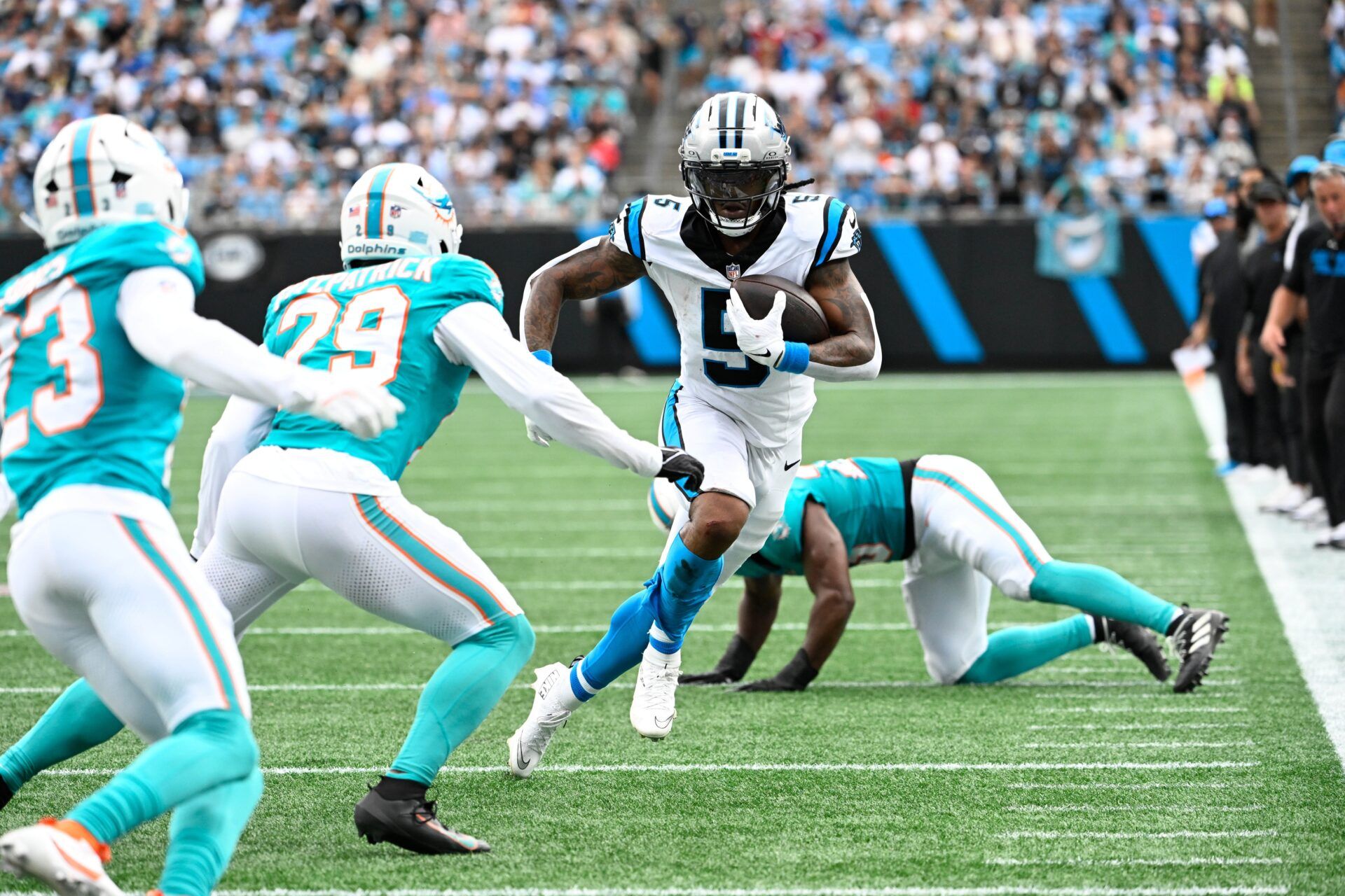 Carolina Panthers running back Rico Dowdle (5) with the ball as Miami Dolphins free safety Minkah Fitzpatrick (29) defends in the second quarter at Bank of America Stadium.