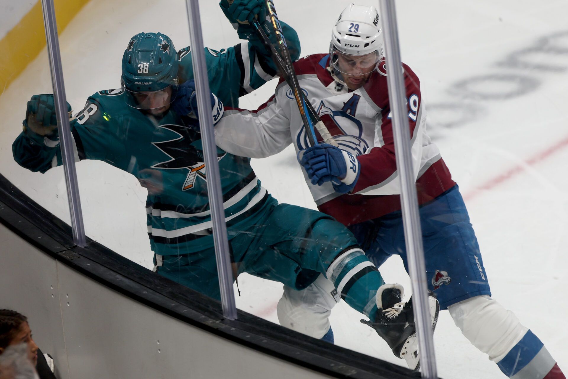 San Jose Sharks defenseman Mario Ferraro (38) is checked by Colorado Avalanche center Nathan MacKinnon (29) during the third period at SAP Center at San Jose.