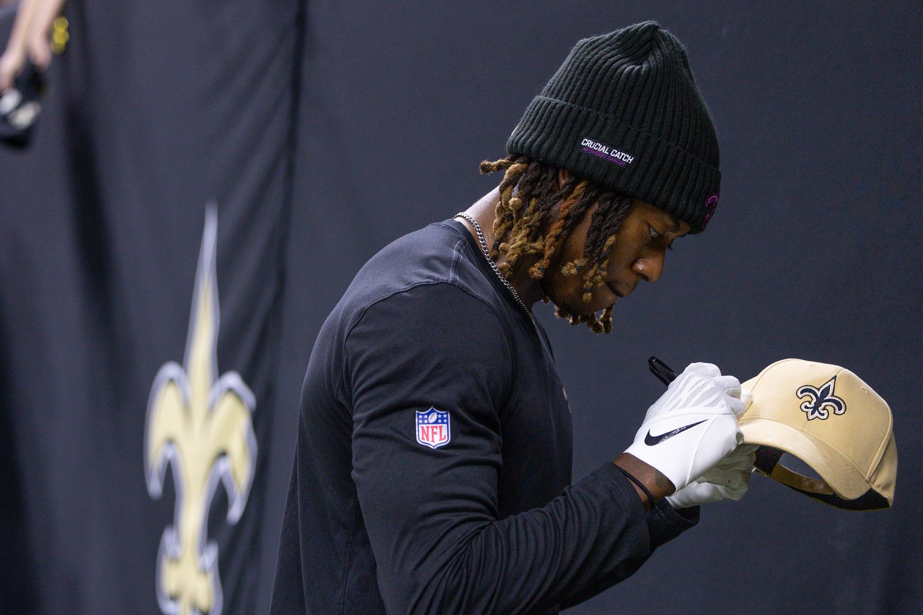 New Orleans Saints wide receiver Rashid Shaheed (22) signs a hat for a fan during warmups before the game against the Tampa Bay Buccaneers at Caesars Superdome.