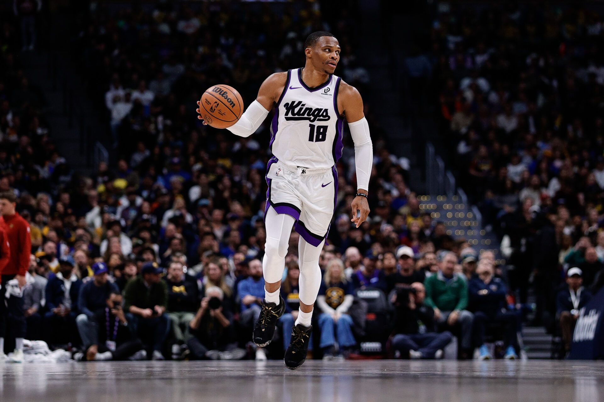 Sacramento Kings guard Russell Westbrook (18) dribbles the ball up court in the fourth quarter against the Denver Nuggets at Ball Arena.