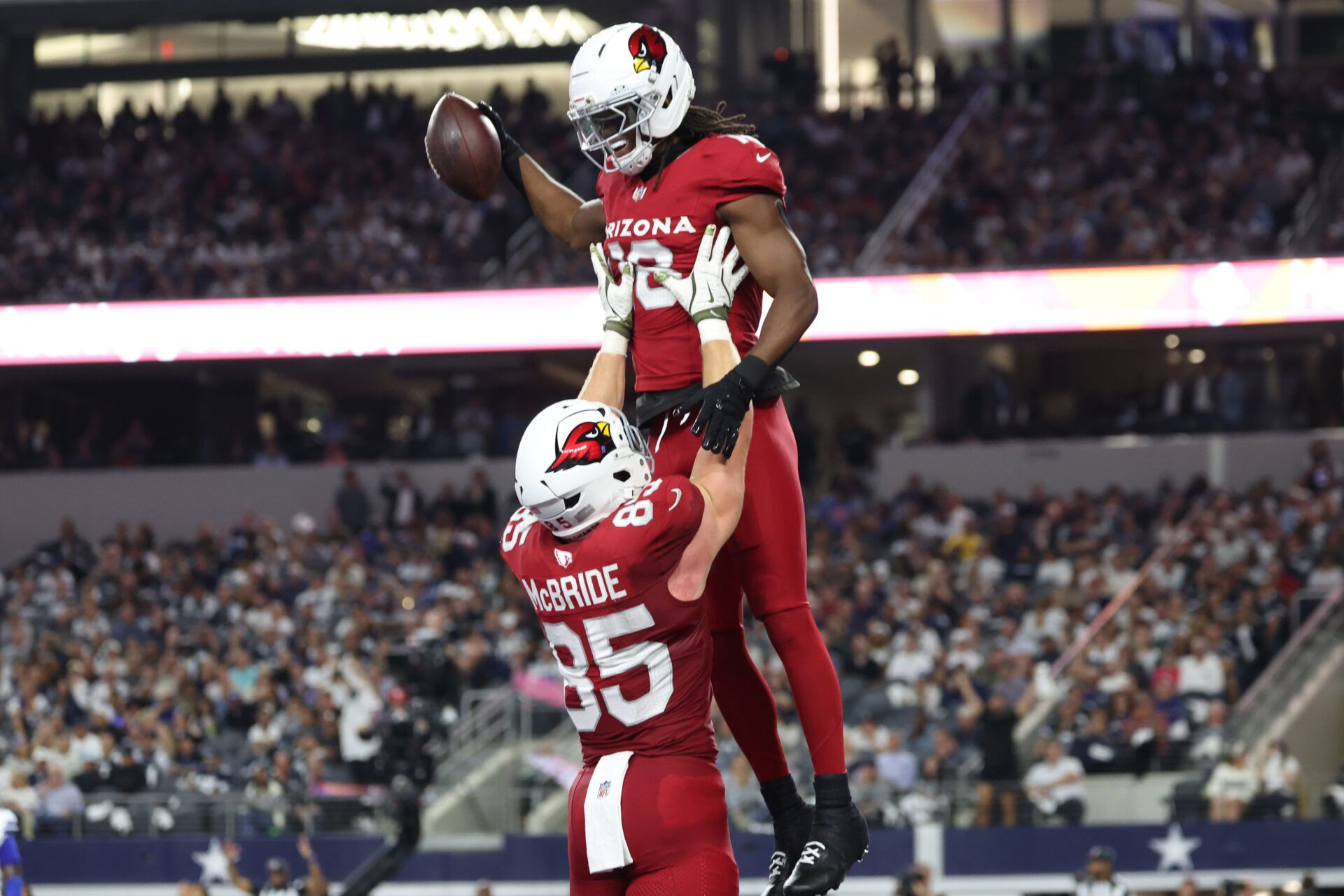 Arizona Cardinals wide receiver Marvin Harrison Jr. (18) celebrates with tight end Trey McBride (85) after scoring a touchdown against the Dallas Cowboys in the first half at AT&T Stadium.