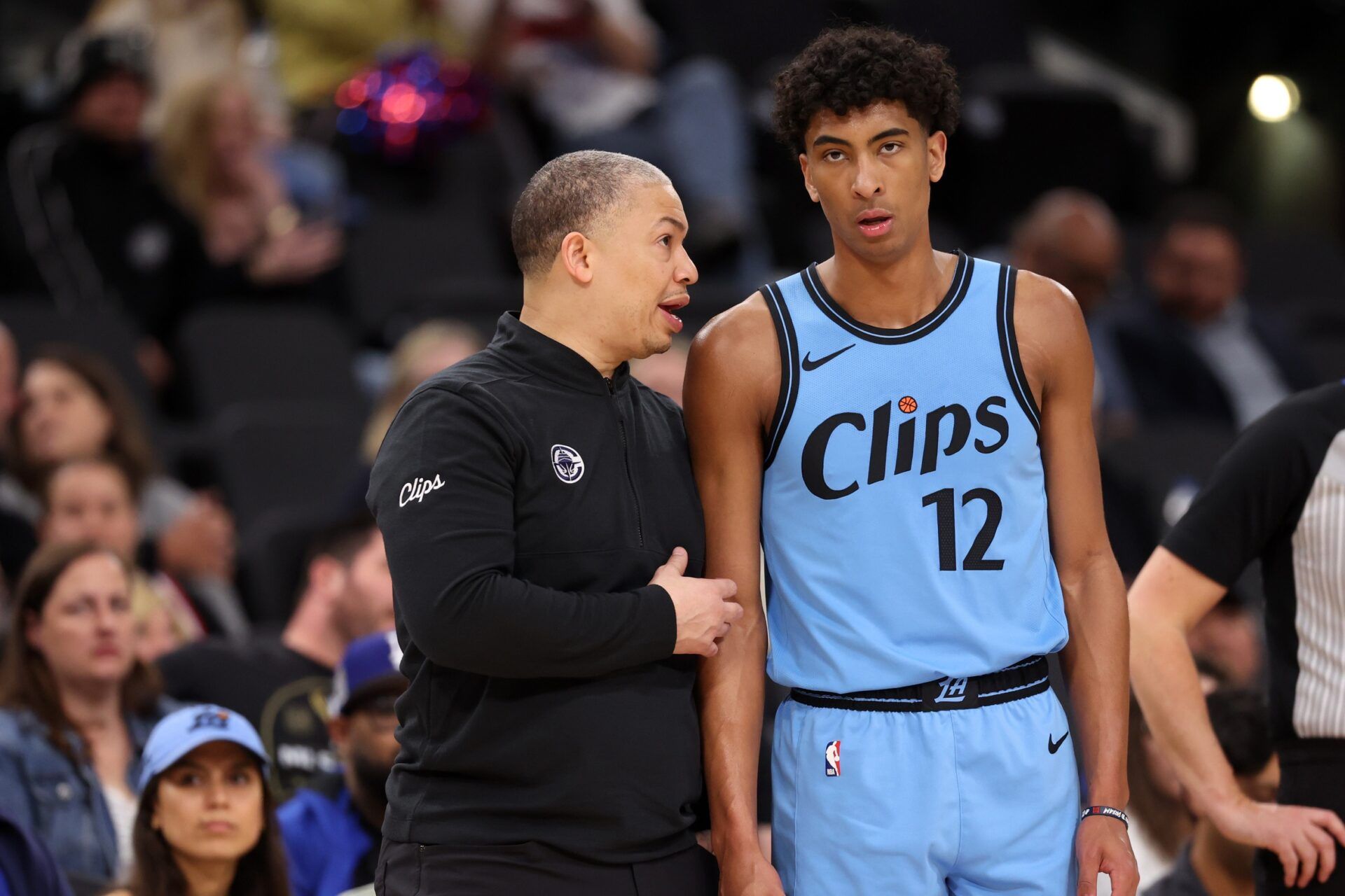 Los Angeles Clippers head coach Tyronn Lue (left) talks to guard Cam Christie (12) during the second half against the Dallas Mavericks at Intuit Dome.