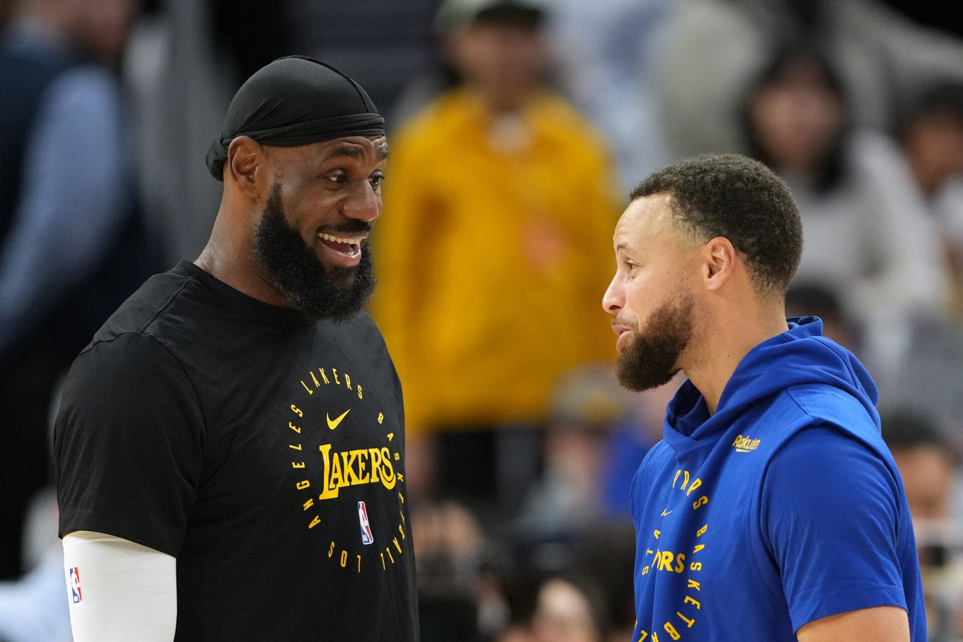 Los Angeles Lakers forward LeBron James (left) and Golden State Warriors guard Stephen Curry (right) talk before the game at Chase Center.