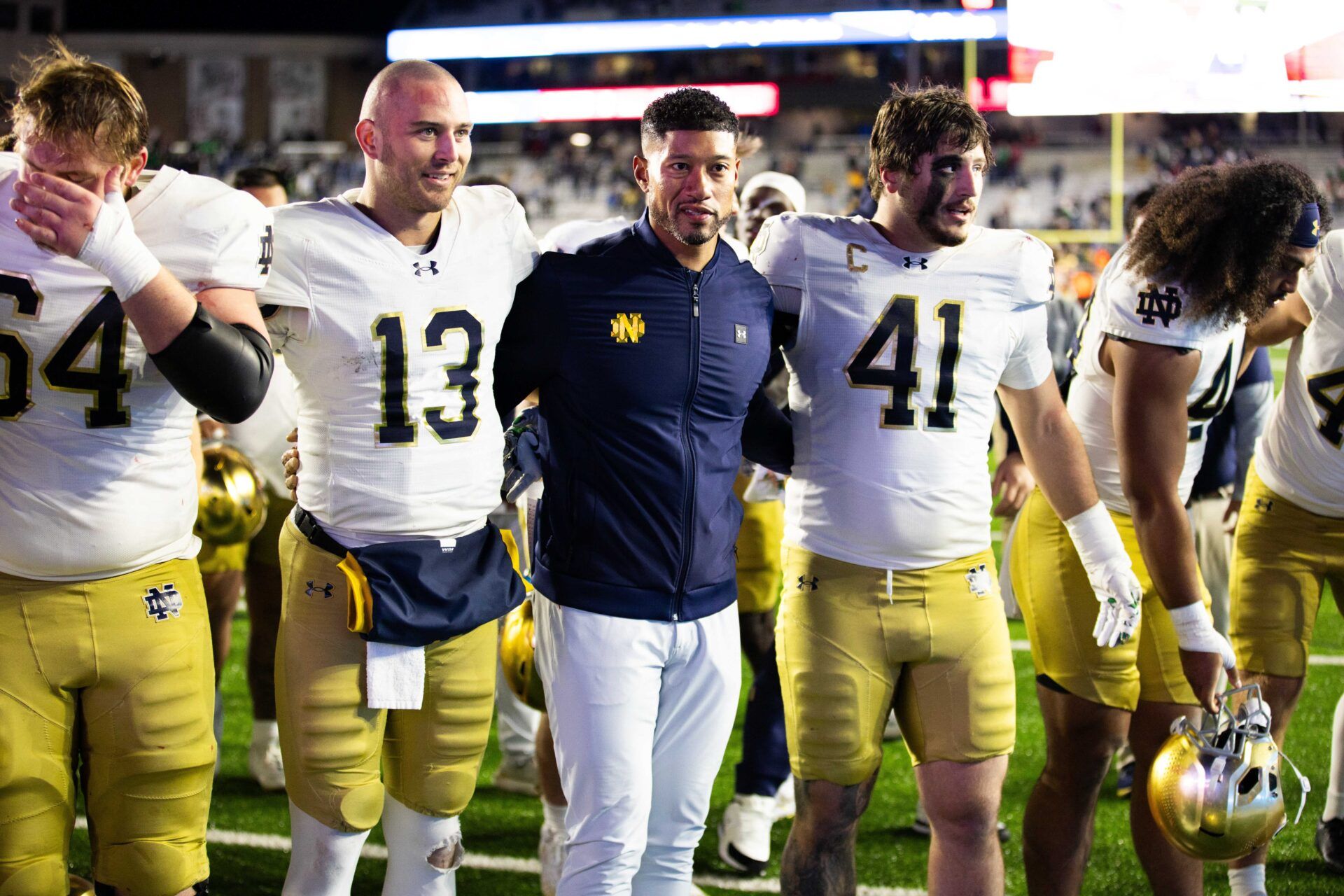 Notre Dame Fighting Irish head coach Marcus Freeman, Notre Dame Fighting Irish quarterback CJ Carr (13) and Notre Dame Fighting Irish defensive lineman Donovan Hinish (41) after the game against the Boston College Eagles at Alumni Stadium.