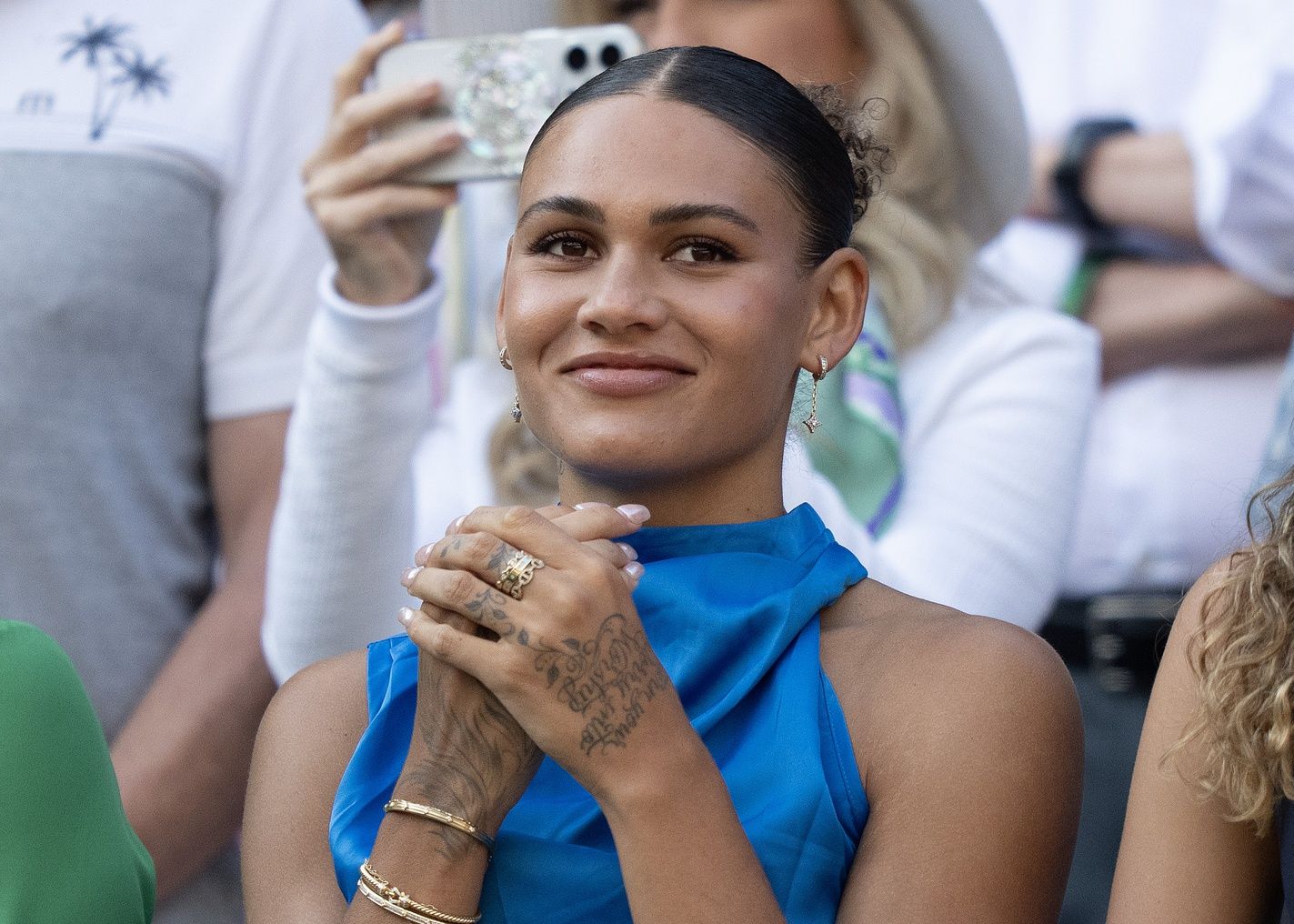 Trinity Rodman reacts to Ben Shelton of the United States winning his match against Lorenzo Sonego of Italy on day eight at All England Lawn Tennis and Croquet Club.