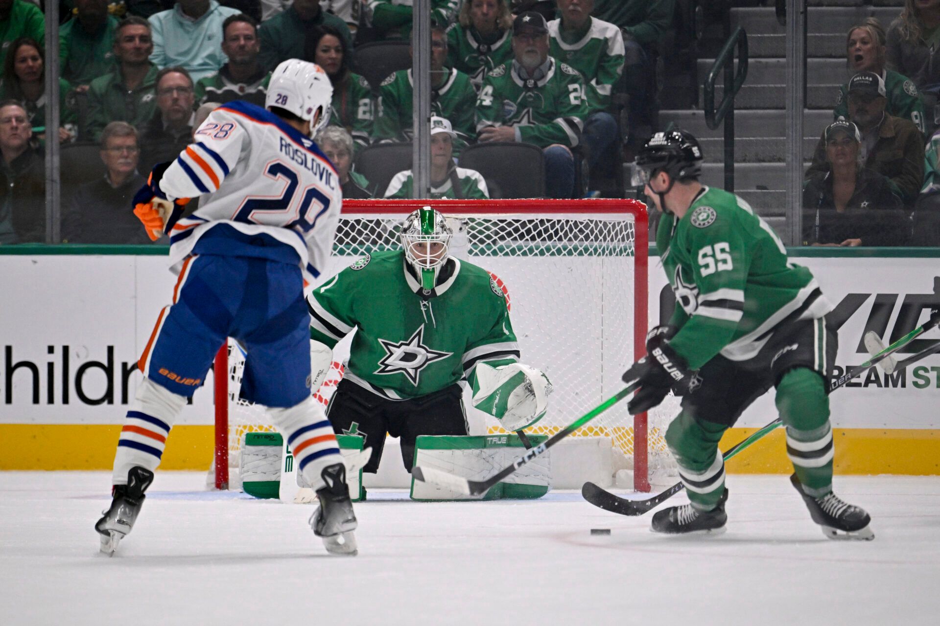 Dallas Stars goaltender Jake Oettinger (29) and defenseman Thomas Harley (55) stop a shot by Edmonton Oilers center Jack Roslovic (28) during the overtime period at the American Airlines Center.