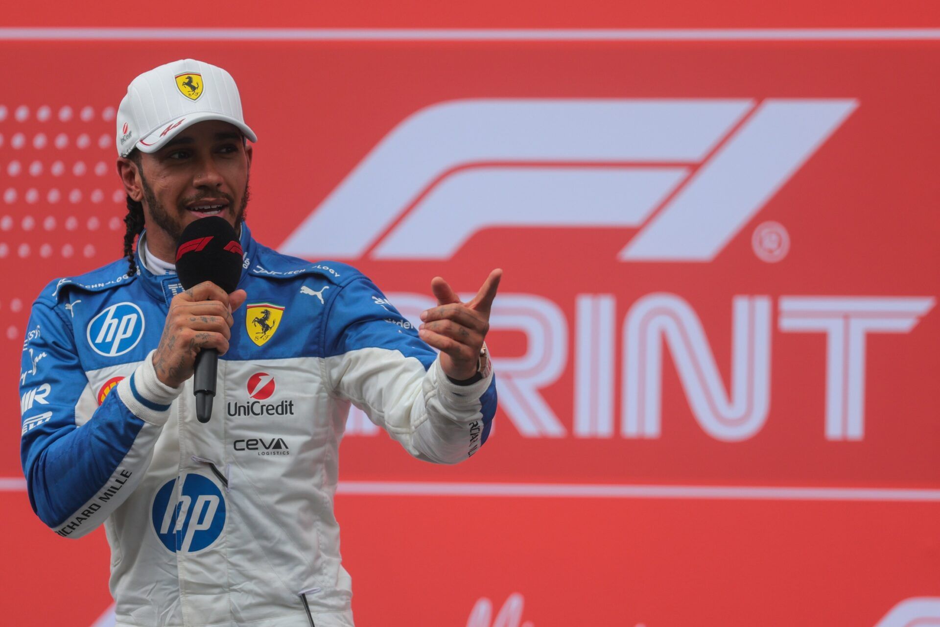 Ferrari driver Lewis Hamilton (44) talks to the media after finishing third during the F1 Miami Grand Prix Sprint Race at Miami International Autodrome.