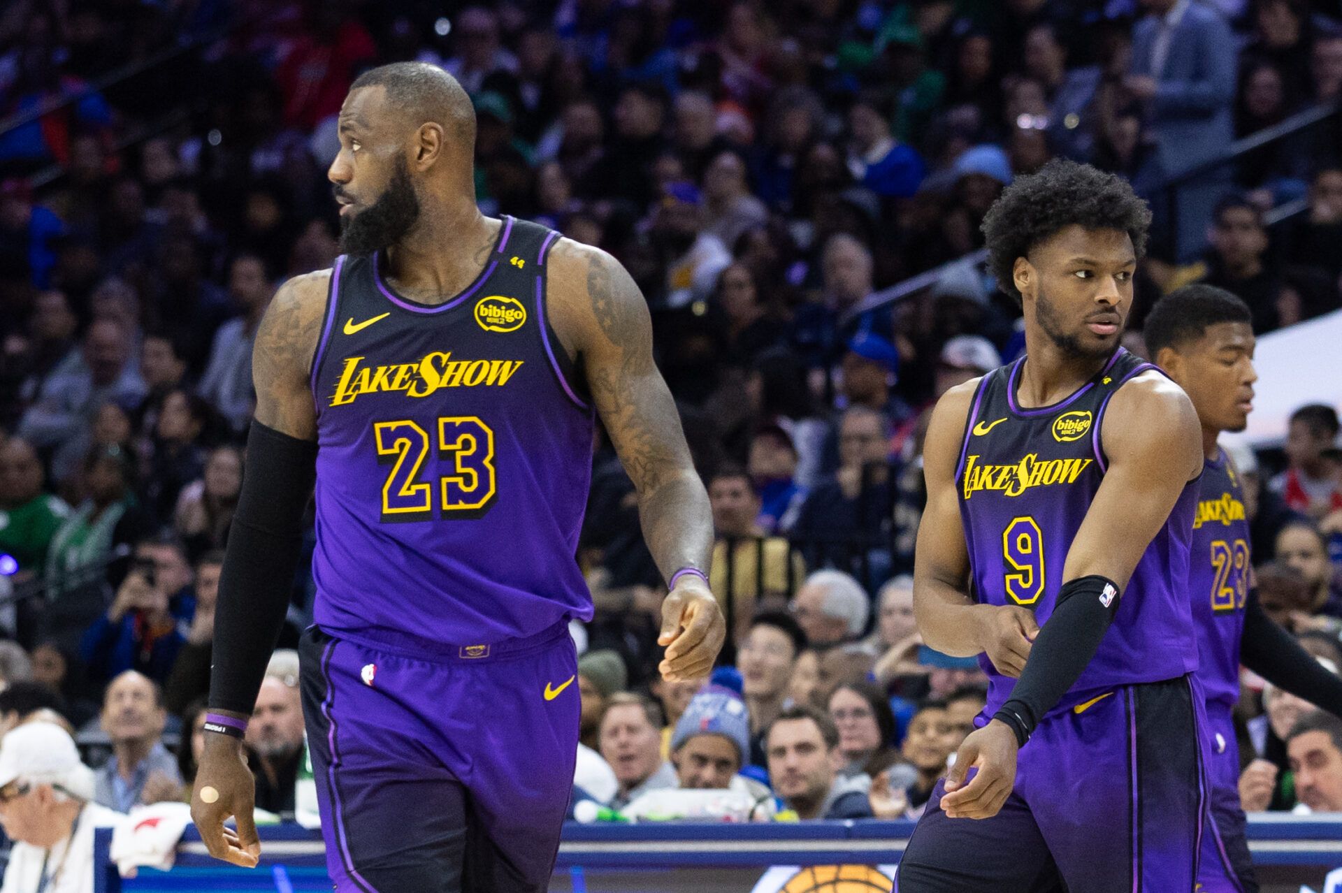 Los Angeles Lakers forward LeBron James (23) and guard Bronny James (9) look on during the third quarter against the Philadelphia 76ers at Wells Fargo Center.