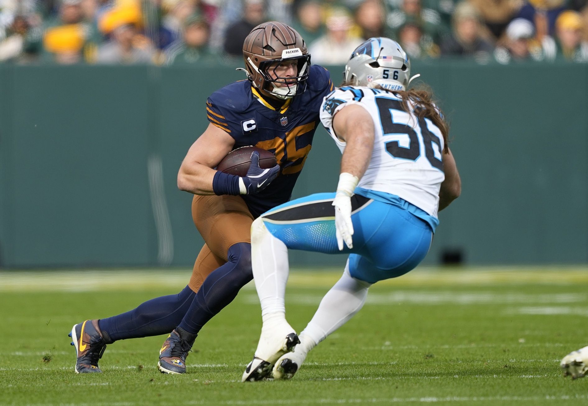 Green Bay Packers tight end Tucker Kraft (85) runs after a catch against Carolina Panthers linebacker Christian Rozeboom (56) during the first half at Lambeau Field.