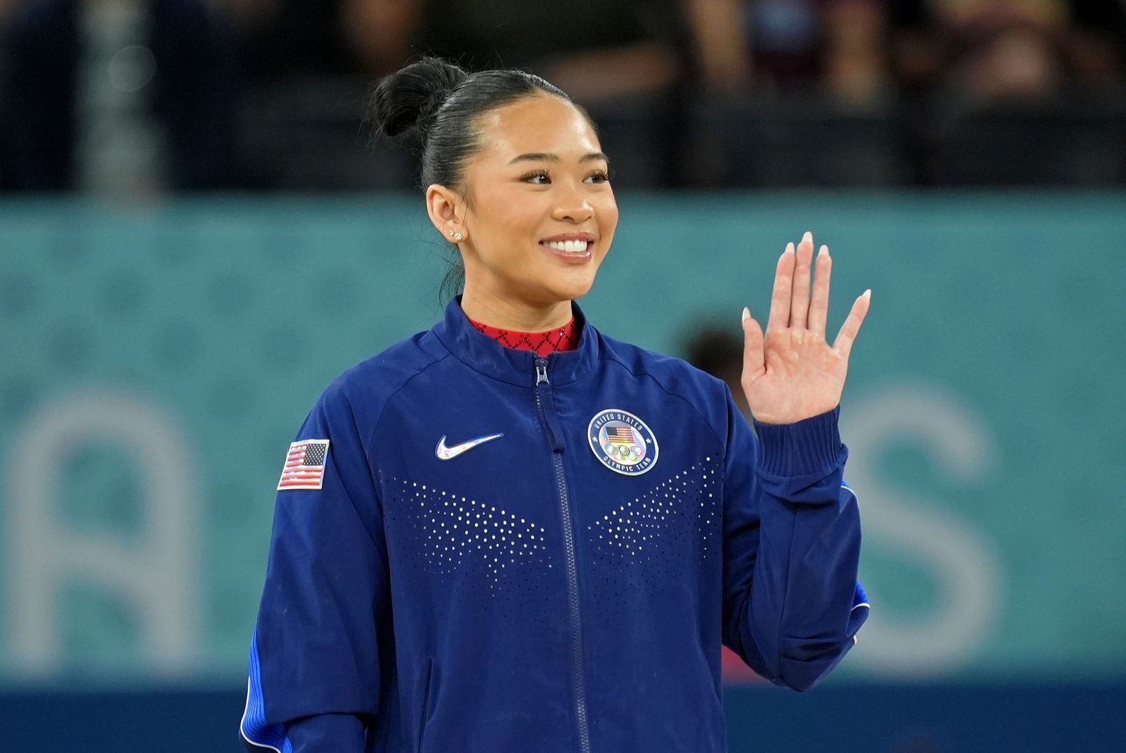 Sunisa Lee of the United States waves after winning the bronze medal on the second day of gymnastics event finals during the Paris 2024 Olympic Summer Games at Bercy Arena.