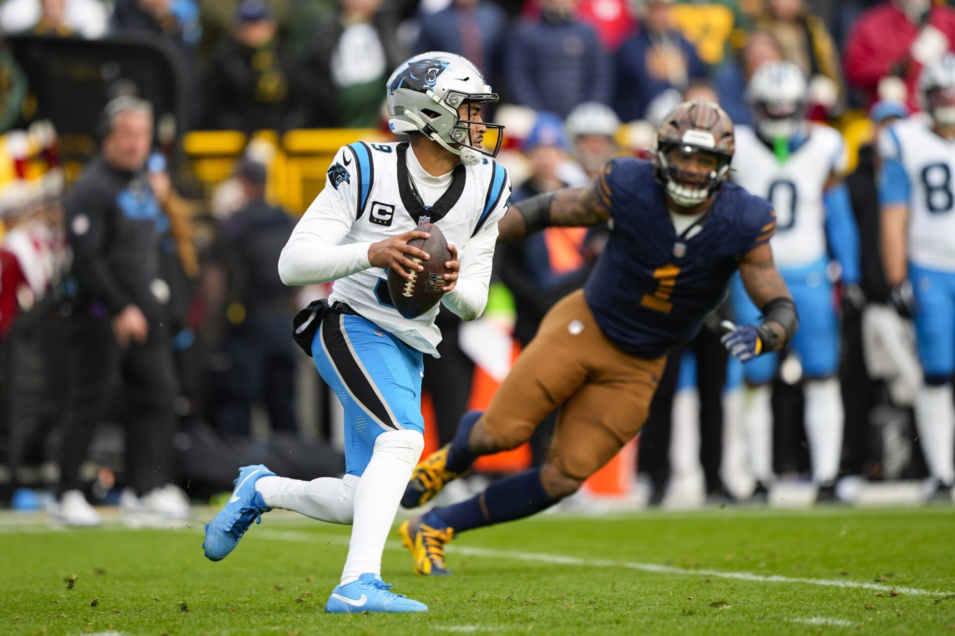 Carolina Panthers quarterback Bryce Young (9) is chased by Green Bay Packers defensive end Micah Parsons (1) during the game at Lambeau Field.
