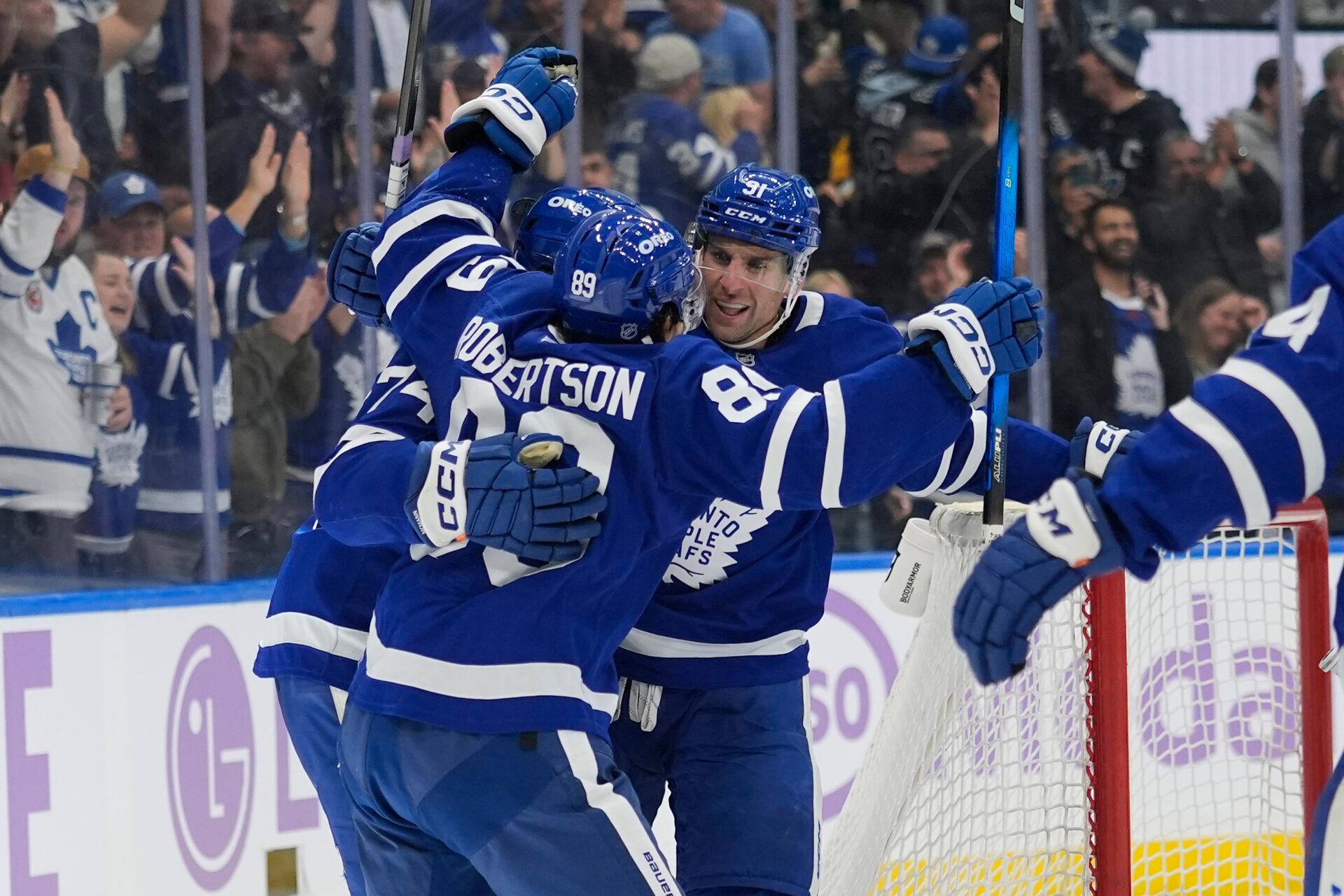 Toronto Maple Leafs forward John Tavares (91) and forward Nic Robertson (89) congratulate forward Bobby McMann (74) on his game winning goal against the Pittsburgh Penguins during the third period at Scotiabank Arena.