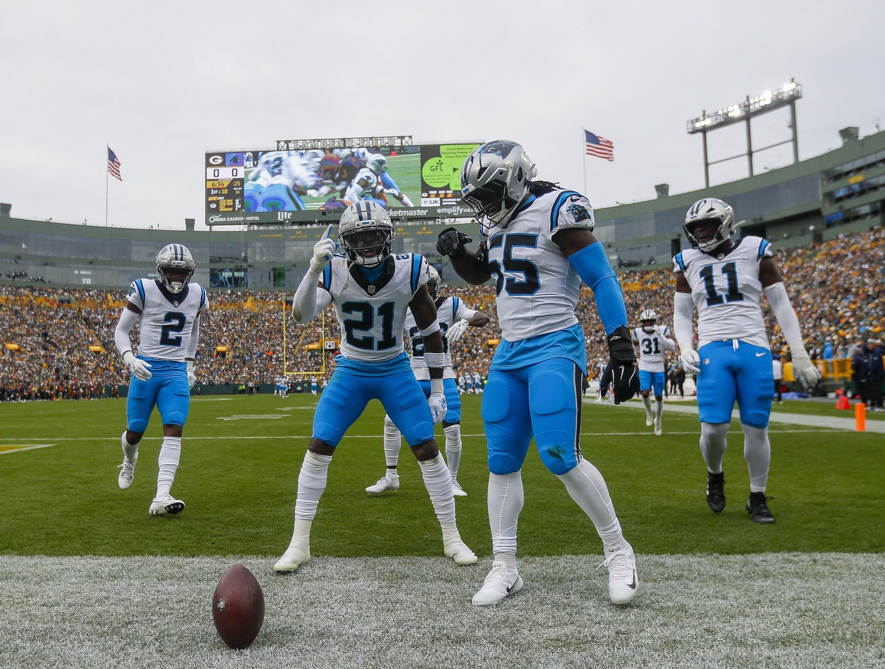 Carolina Panthers safety Nick Scott (21) and linebacker Maema Njongmeta (55) celebrate after Scott recovers a fumble against the Green Bay Packers during the game at Lambeau Field.