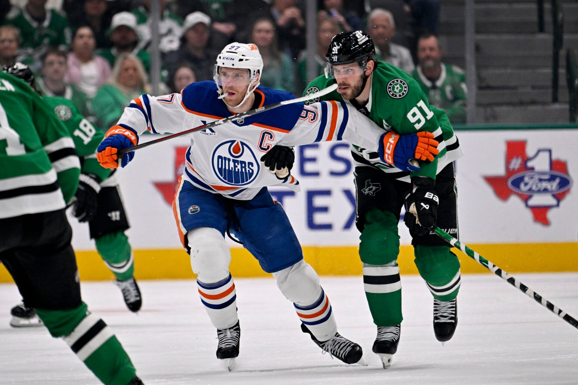 Edmonton Oilers center Connor McDavid (97) and Dallas Stars center Tyler Seguin (91) chase the puck during the third period at the American Airlines Center.