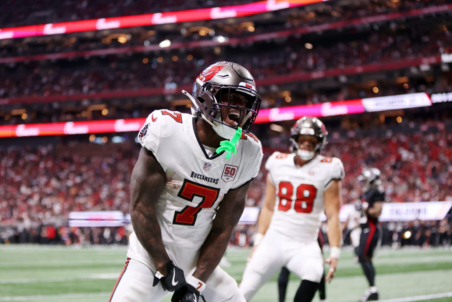 Tampa Bay Buccaneers running back Bucky Irving (7) celebrates after scoring a touchdown against the Atlanta Falcons during the third quarter at Mercedes-Benz Stadium.