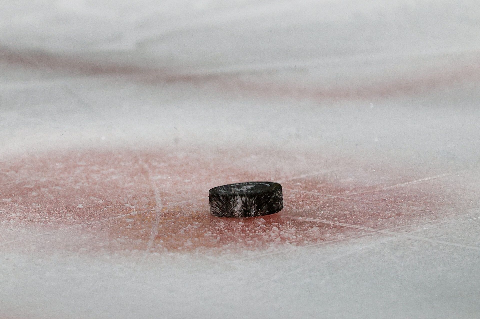 The puck hits the ice during a face off in the first period between the Colorado Avalanche and the New Jersey Devils at Ball Arena.