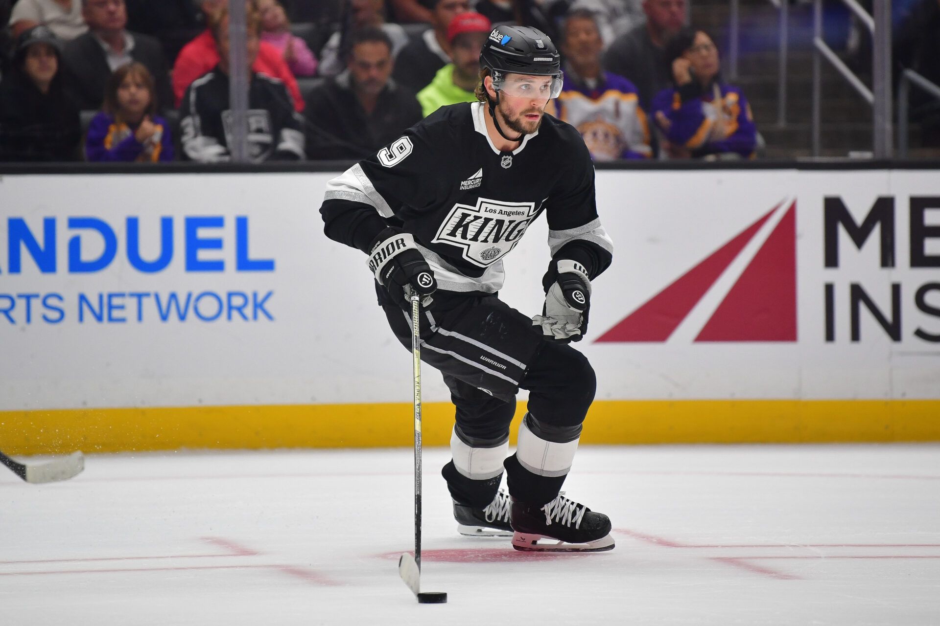 Los Angeles Kings right wing Adrian Kempe (9) moves the puck against the Detroit Red Wings during the first period at Crypto.com Arena.