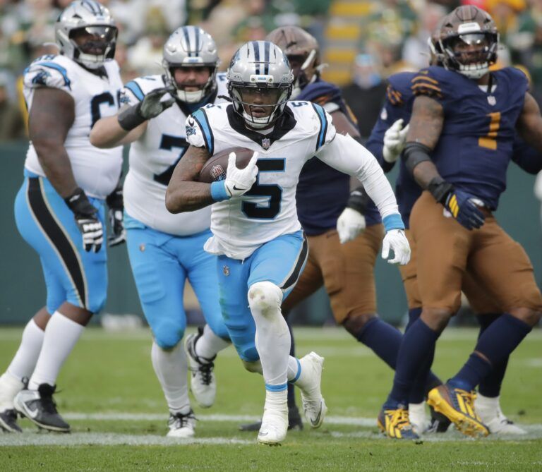Carolina Panthers running back Rico Dowdle (5) breaks away for a long gain with less than a minute left in the game against the Green Bay Packers during their football game at Lambeau Field.