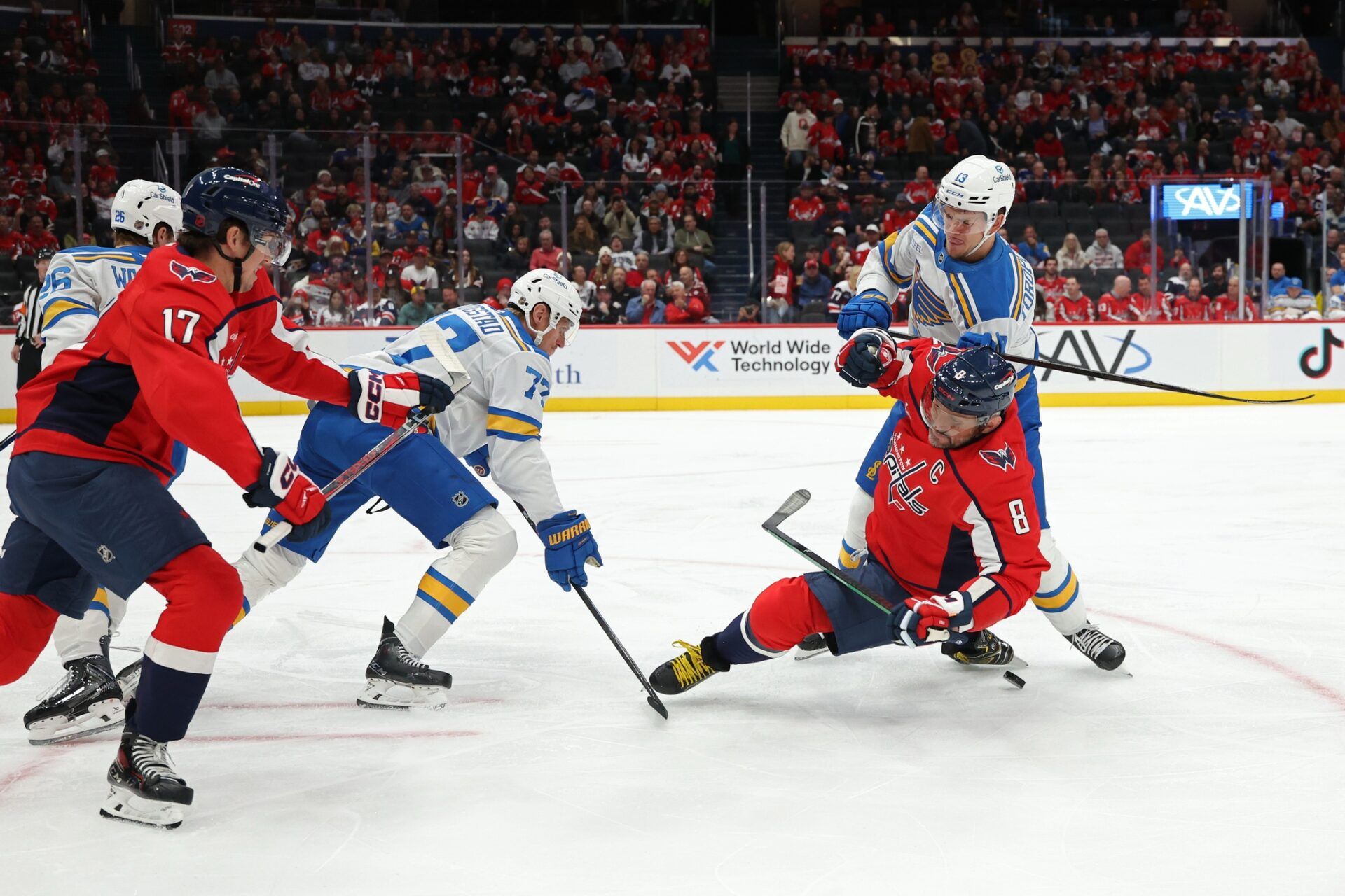 Washington Capitals left wing Alex Ovechkin (8) is checked by St. Louis Blues right wing Alexey Toropchenko (13) while battling for the puck during the first period at Capital One Arena.