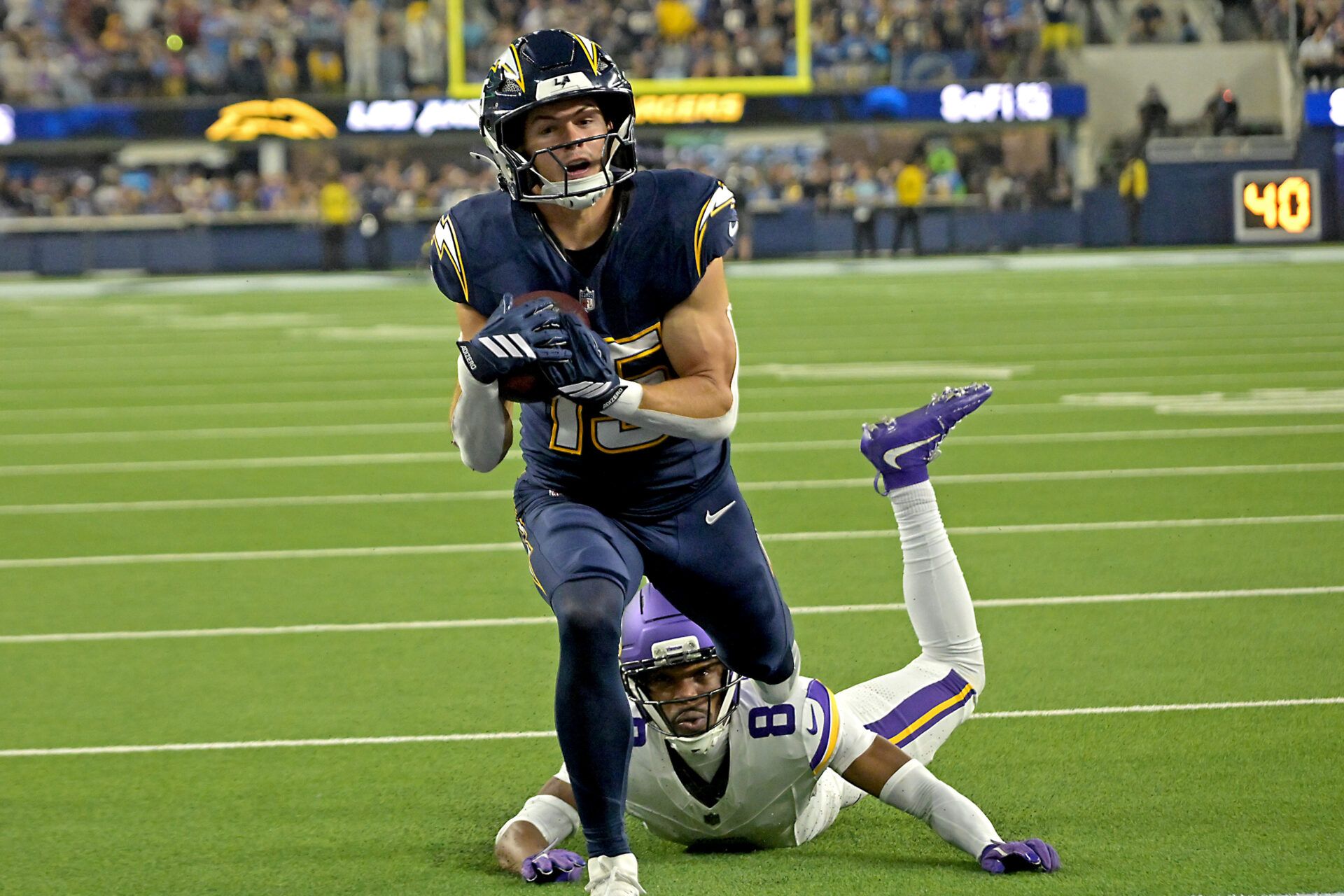 Los Angeles Chargers wide receiver Ladd McConkey (15) gets by Minnesota Vikings cornerback Jeff Okudah (8) for a touchdown pass in the second half at SoFi Stadium.