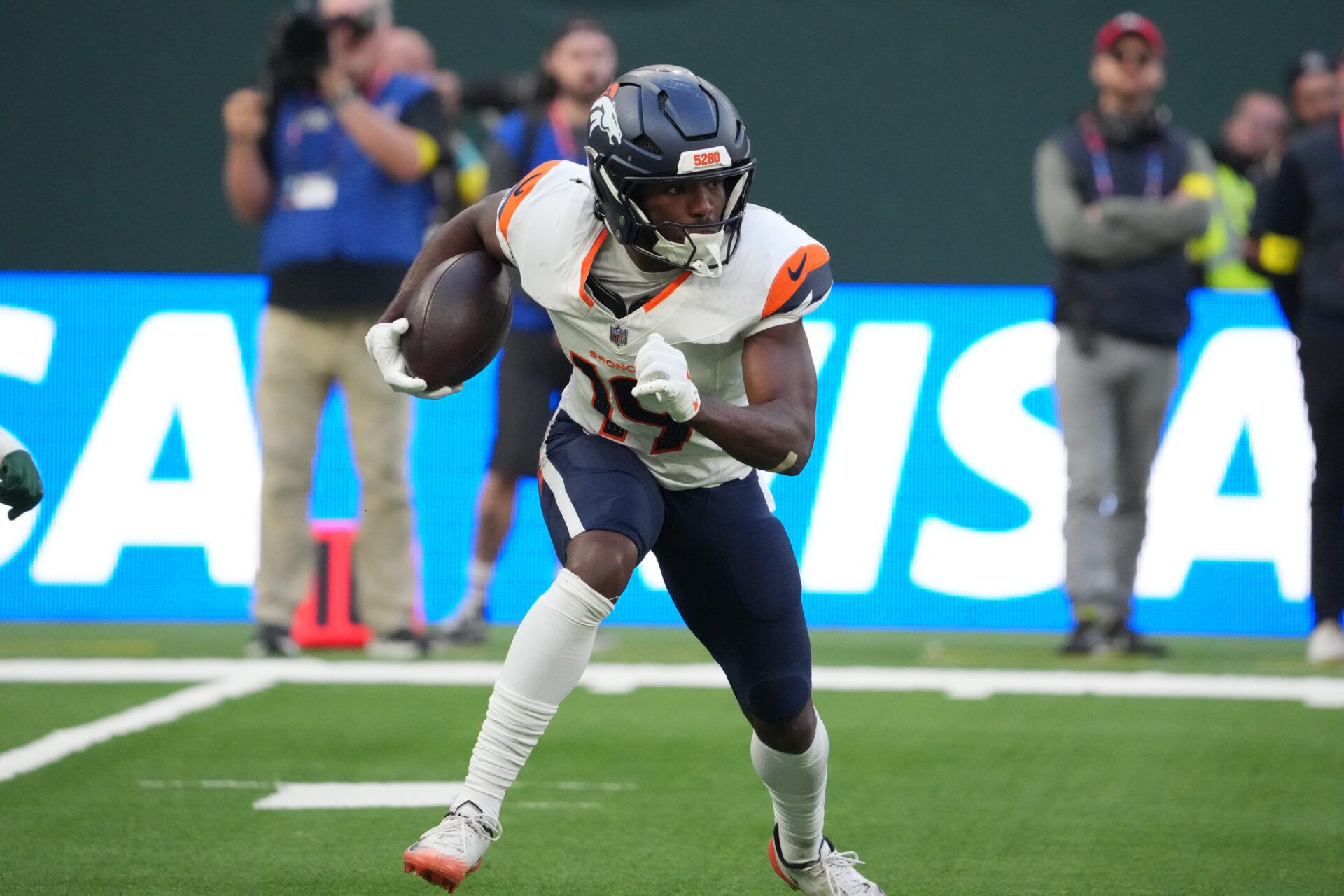 Denver Broncos wide receiver Marvin Mims Jr. (19) carries the ball against the New York Jets during an NFL International Series game at Tottenham Hotspur Stadium.