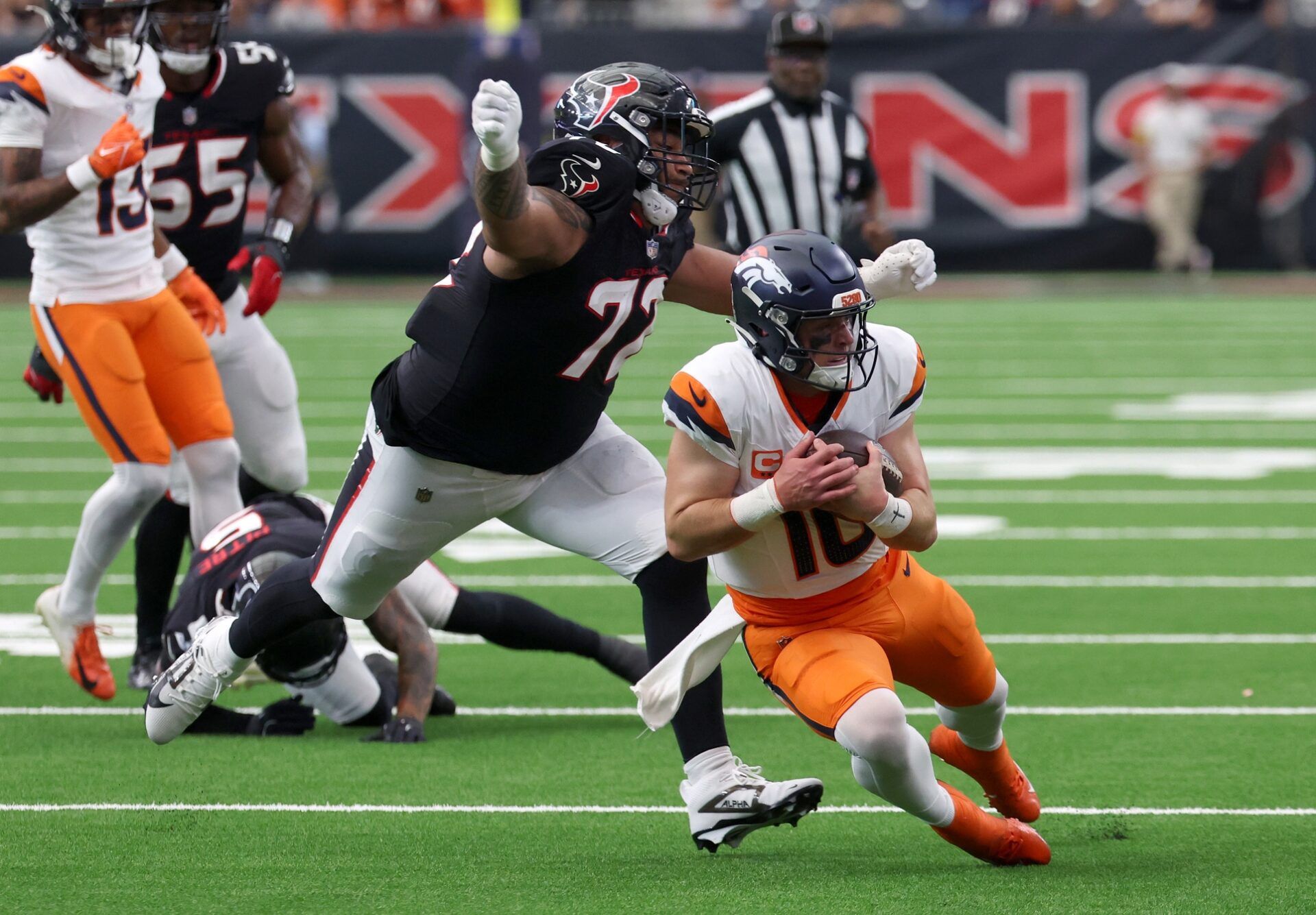 Denver Broncos quarterback Bo Nix (10) scrambles against Houston Texans defensive tackle Tommy Togiai (72) during the second half at NRG Stadium.