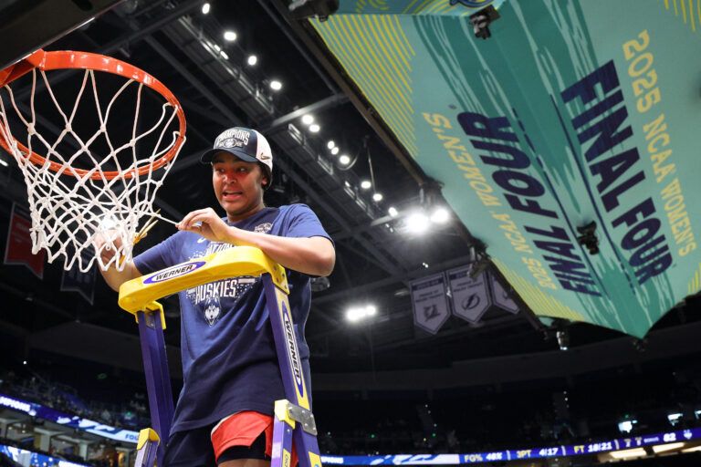 Connecticut Huskies forward Sarah Strong (21) cuts off a piece of the net after the national championship of the women's 2025 NCAA tournament against the South Carolina Gamecocks at Amalie Arena.