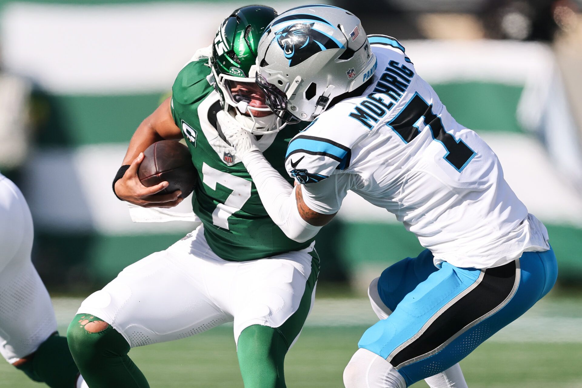 New York Jets quarterback Justin Fields (7) is sacked by Carolina Panthers safety Tre'von Moehrig (7) in the second quarter at MetLife Stadium.