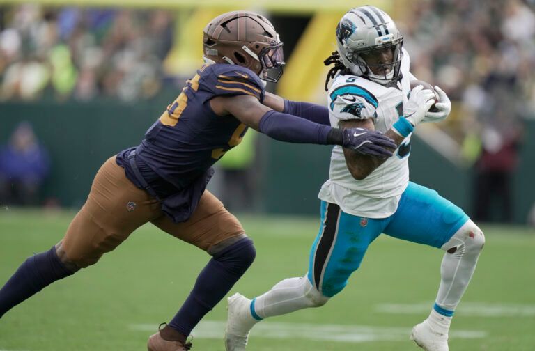 Green Bay Packers' Edgerrin Cooper (56) pursues Carolina Panthers running back Rico Dowdle (5) during the third quarter of their game at Lambeau Field.
