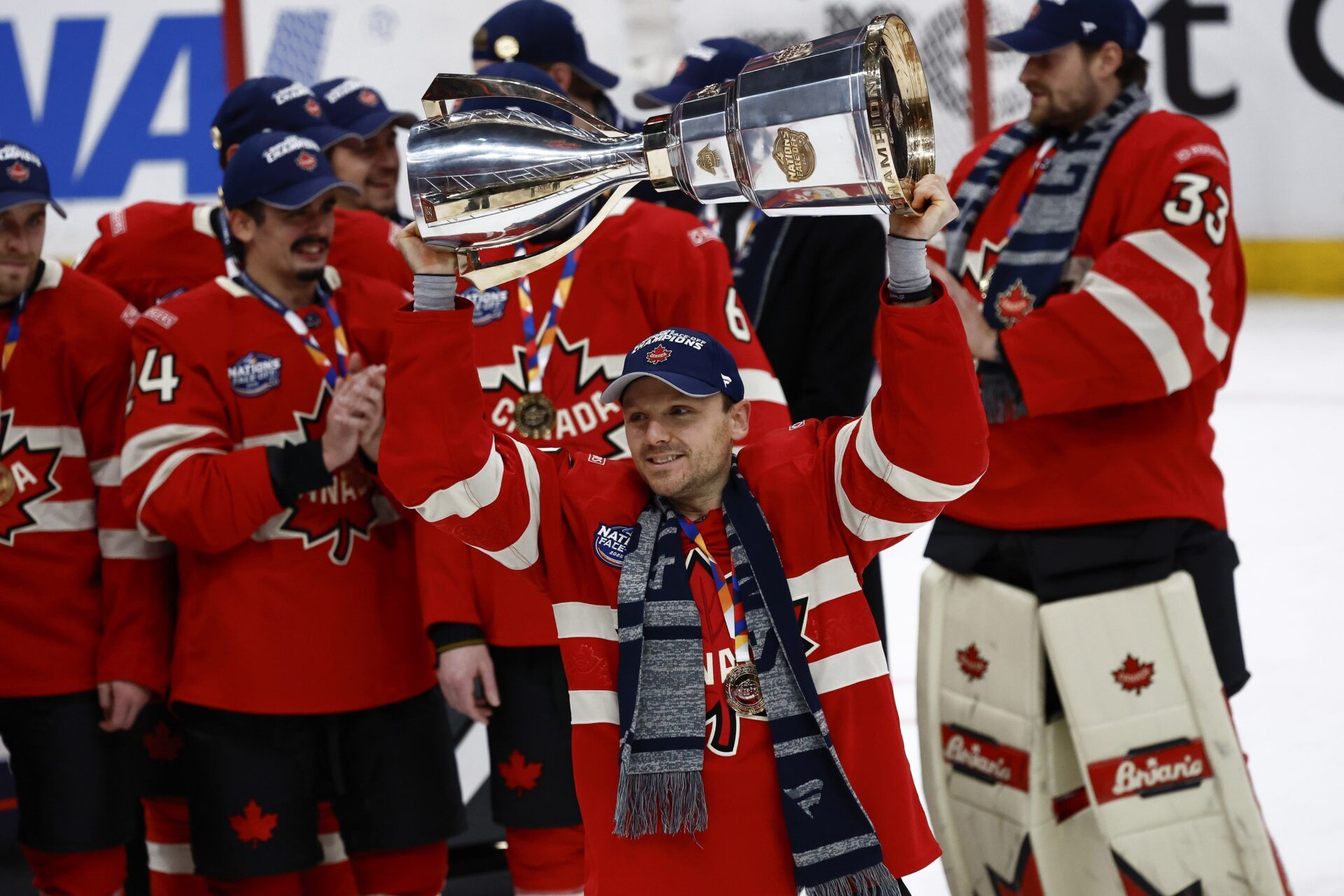 [Imagn Images direct customers only] Team Canada forward Sam Reinhart (13) lifts the trophy after defeating the United States during the 4 Nations Face-Off ice hockey championship game at TD Garden.