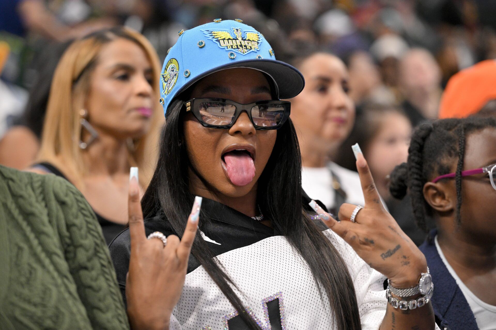 Olympic gymnast Jordan Chiles poses for a photo during the second half of the game between the Dallas Wings and the Indiana Fever at the American Airlines Center.