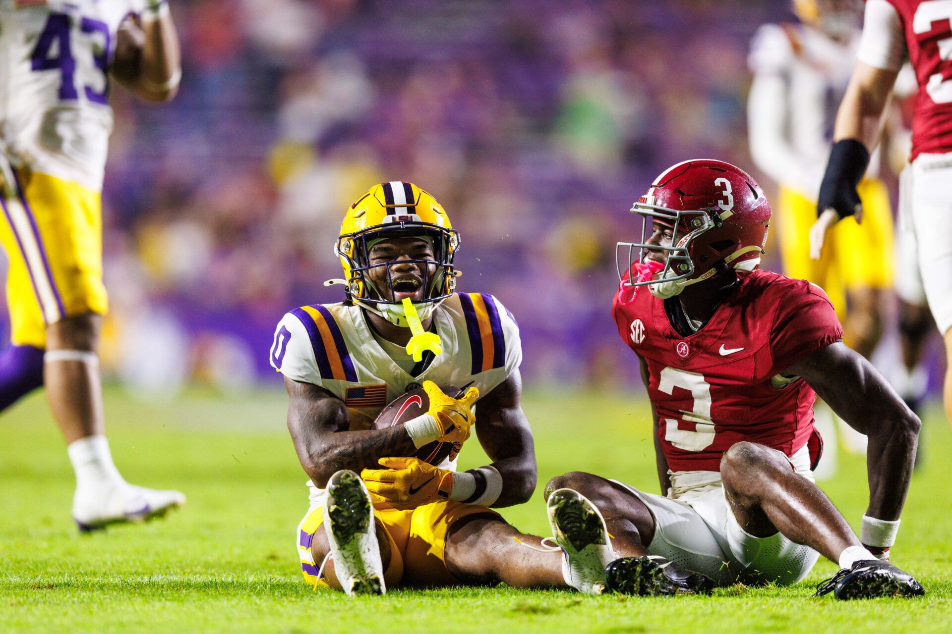 LSU Tigers wide receiver Zavion Thomas (0) reacts to slipping on a kickoff against Alabama Crimson Tide defensive back Keon Sabb (3) during the second half at Tiger Stadium.